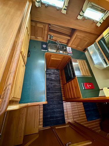 Interior of 1997 Sabre Cockpit Motor Yacht with wood cabinetry and compact kitchen.