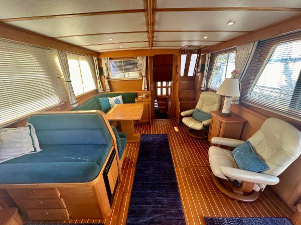 Interior of 1997 Sabre Cockpit Motor Yacht with cozy seating and wooden finishes.