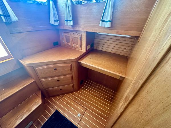1997 Sabre Cockpit Motor Yacht interior with wooden cabinetry and flooring.