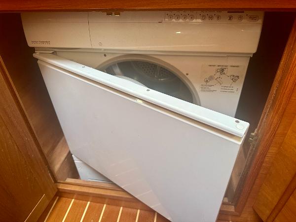 Washer-dryer unit in 1997 Sabre Cockpit Motor Yacht's wooden cabinet.