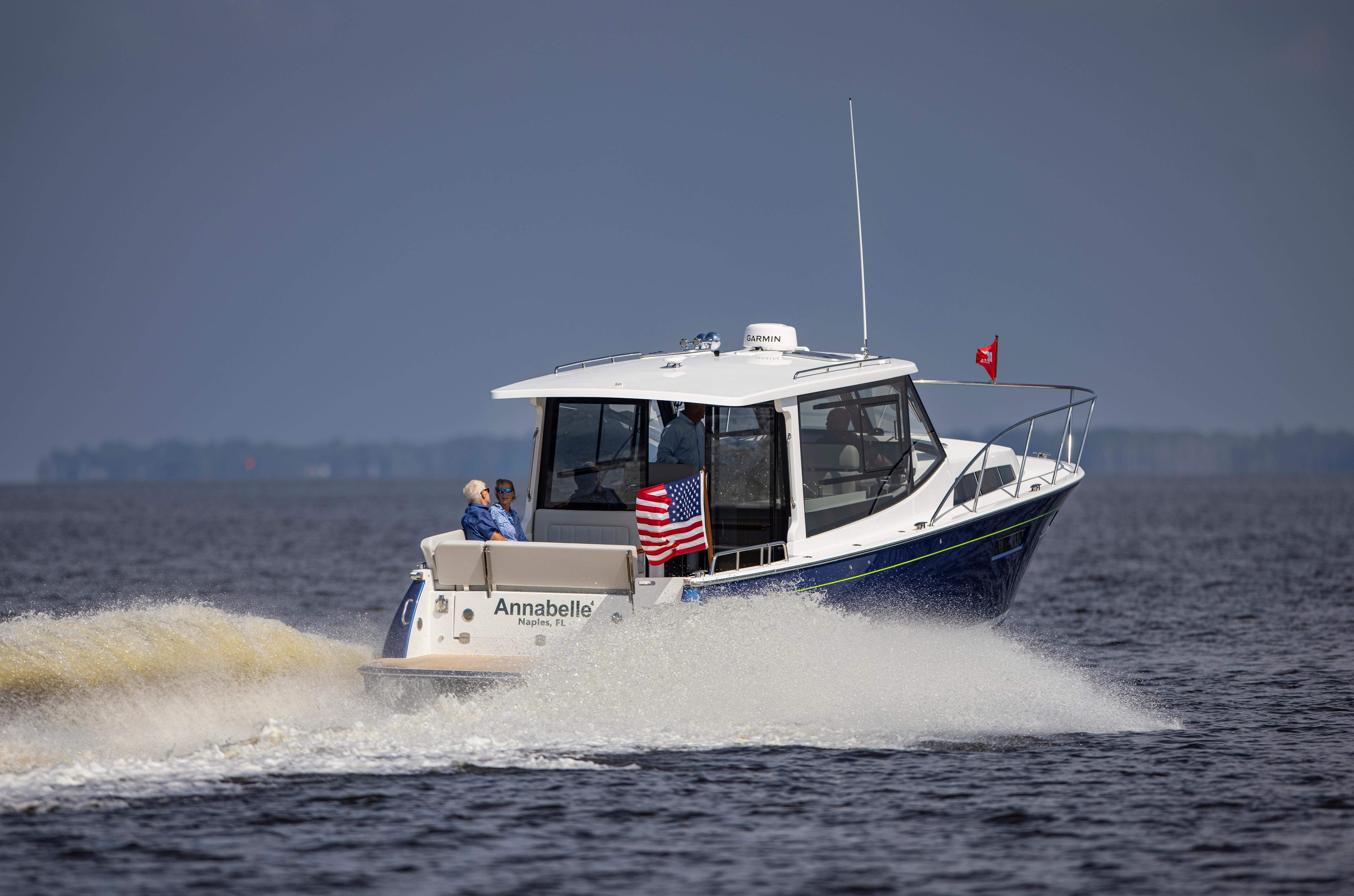 2025 MJM 42 boat cruising on open water with American flag.