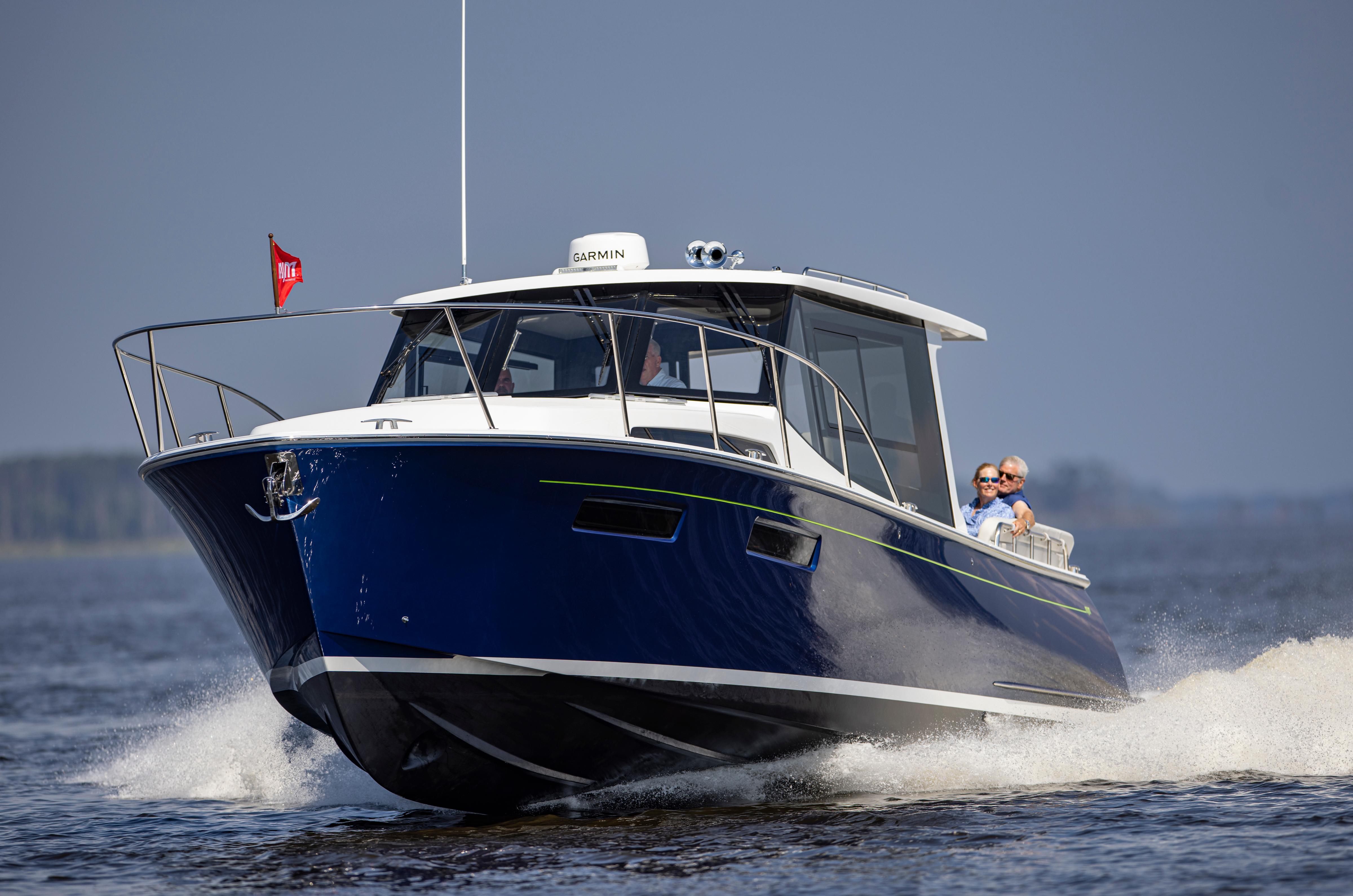 2025 MJM 42 boat cruising on open water with passengers enjoying the ride.