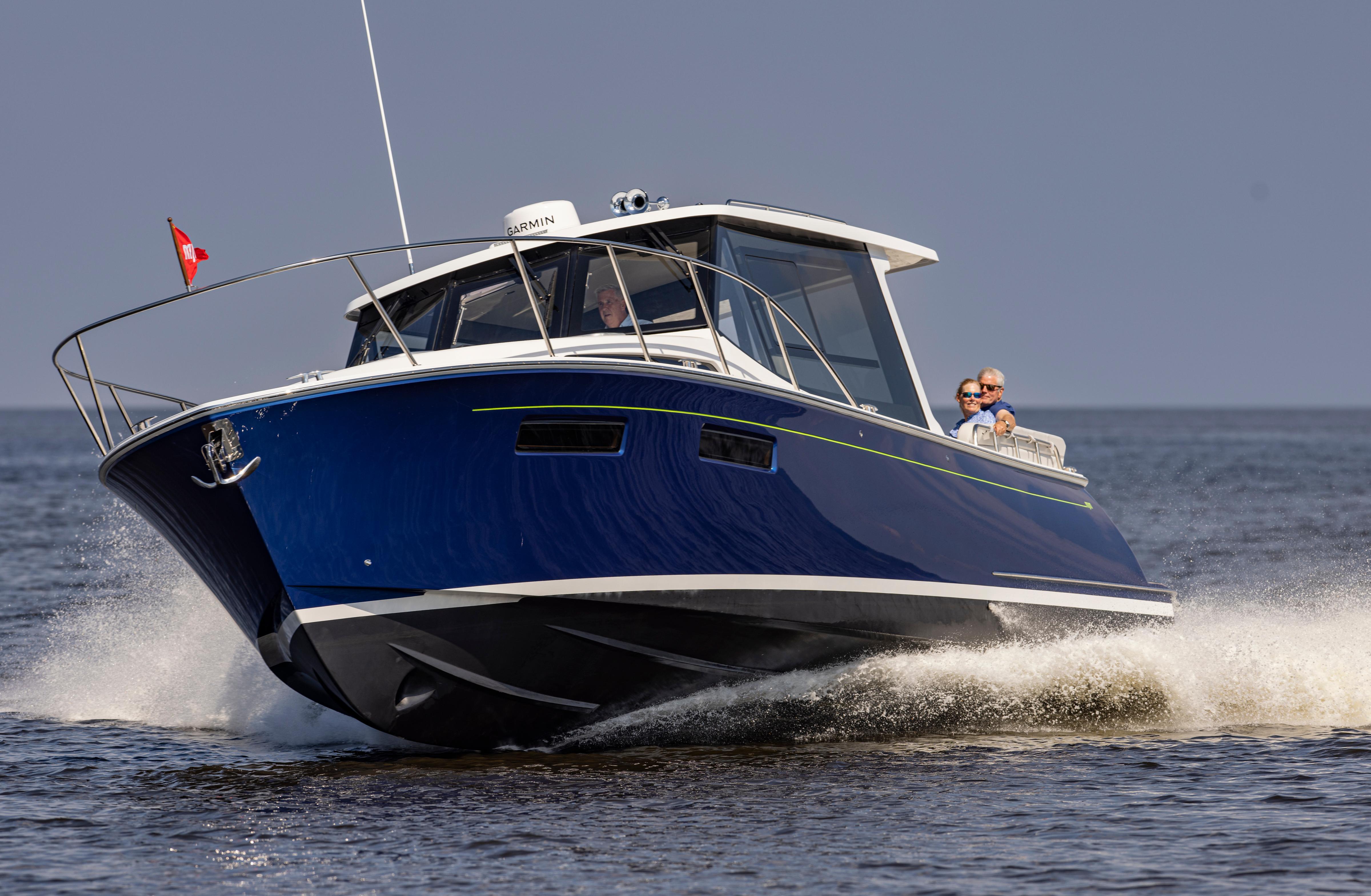 2025 MJM 42 boat cruising on open water, featuring sleek blue design and modern amenities.