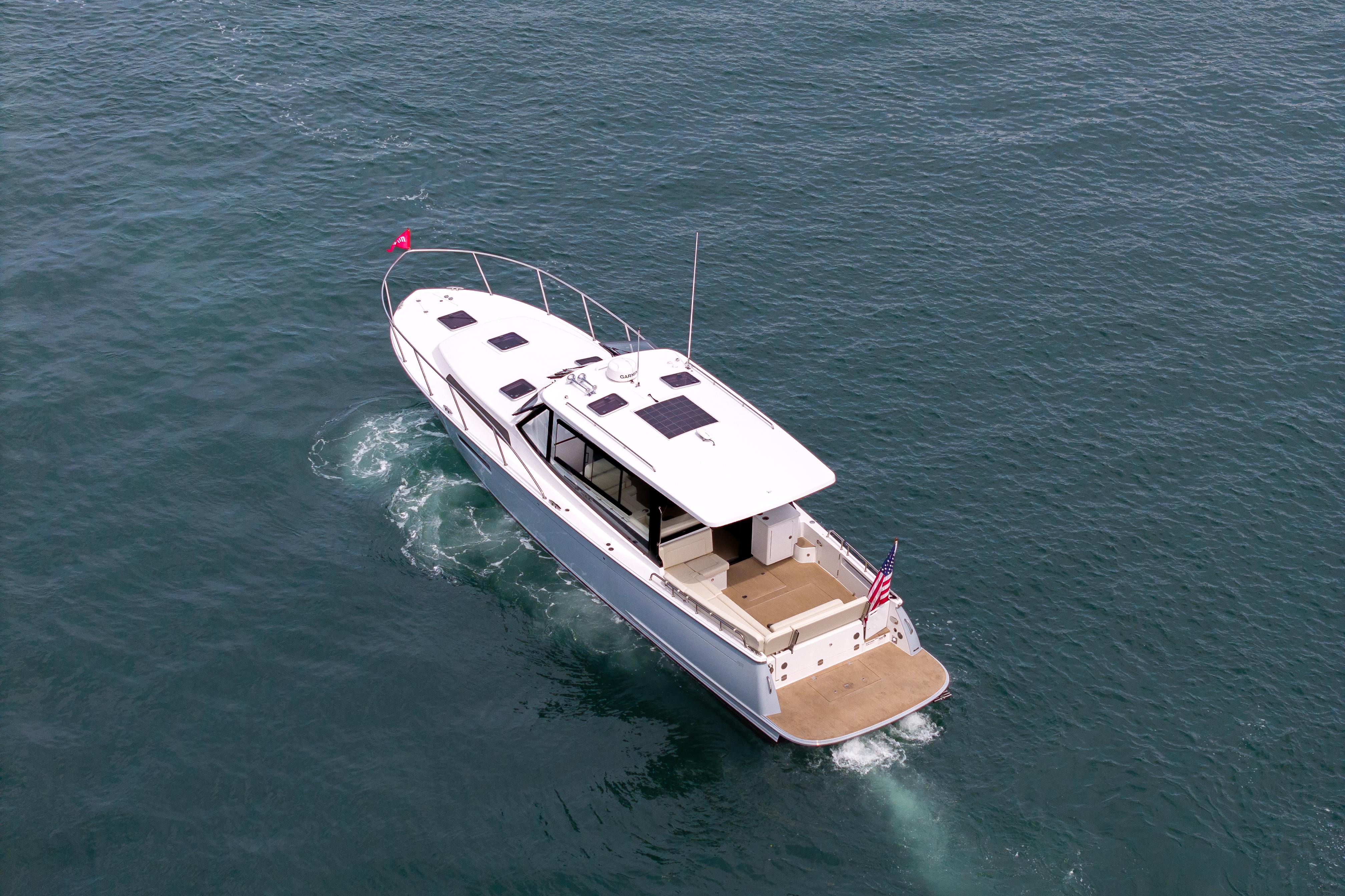 2025 MJM 42 yacht cruising on open water, aerial view.
