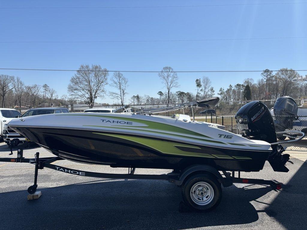 2024 Tahoe T16 boat on trailer, side view, outdoors, sunny day.