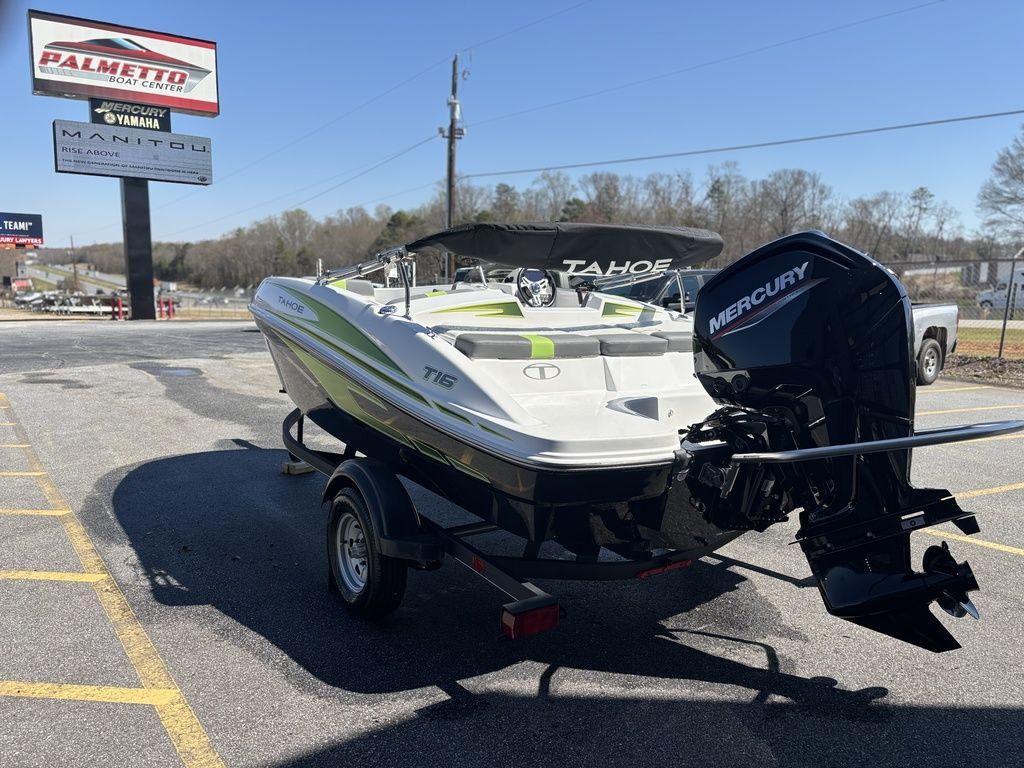 2024 Tahoe T16 boat with Mercury engine on trailer in parking lot.