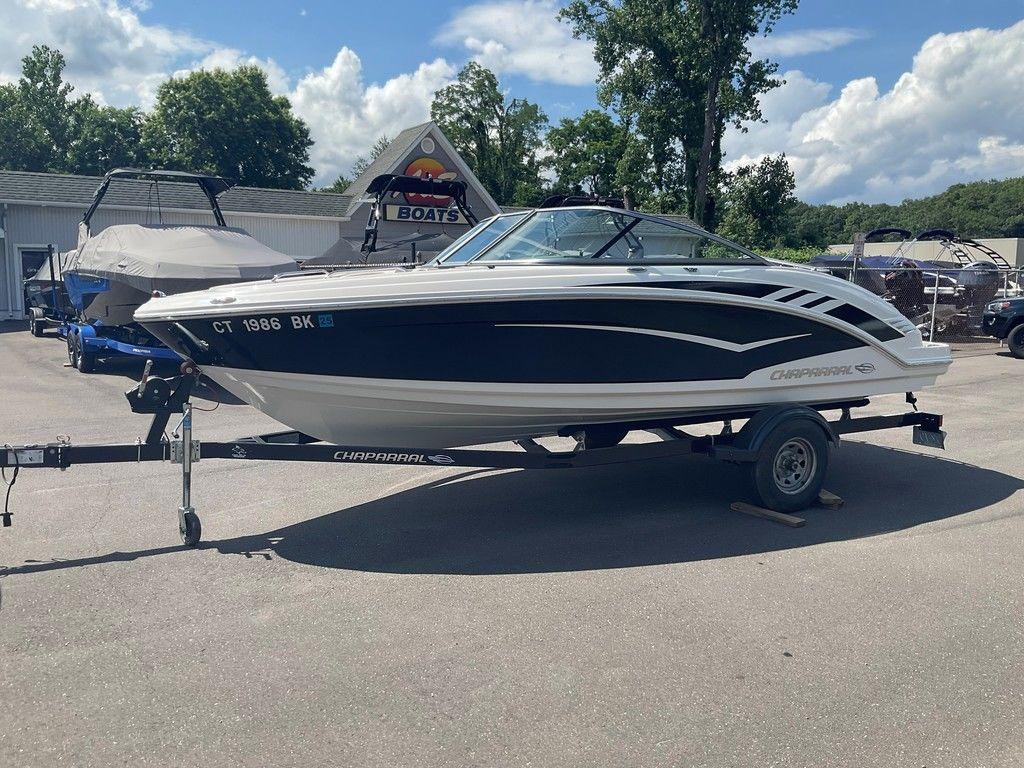 2018 Chaparral 203 VR boat on trailer, parked outdoors under a clear sky.