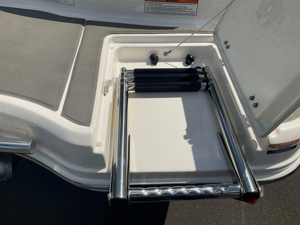 2018 Chaparral 203 VR boat with foldable stainless steel ladder on deck.