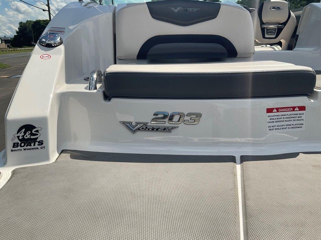 2018 Chaparral 203 VR boat rear view with seating and safety warning.