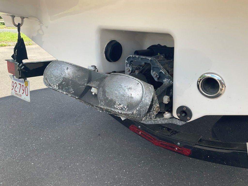 Rear view of a 2018 Chaparral 203 VR boat with trailer hitch and Massachusetts license plate.