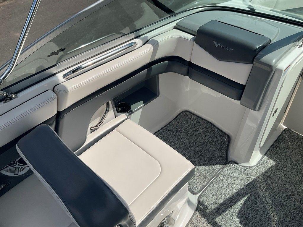 2018 Chaparral 203 VR boat interior with gray seating and carpeted flooring.