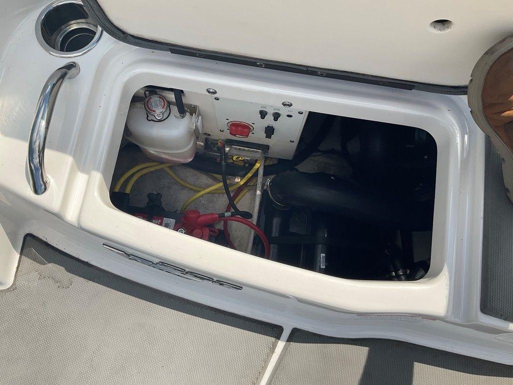 Engine compartment of a 2018 Chaparral 203 VR boat, showing wiring and components.