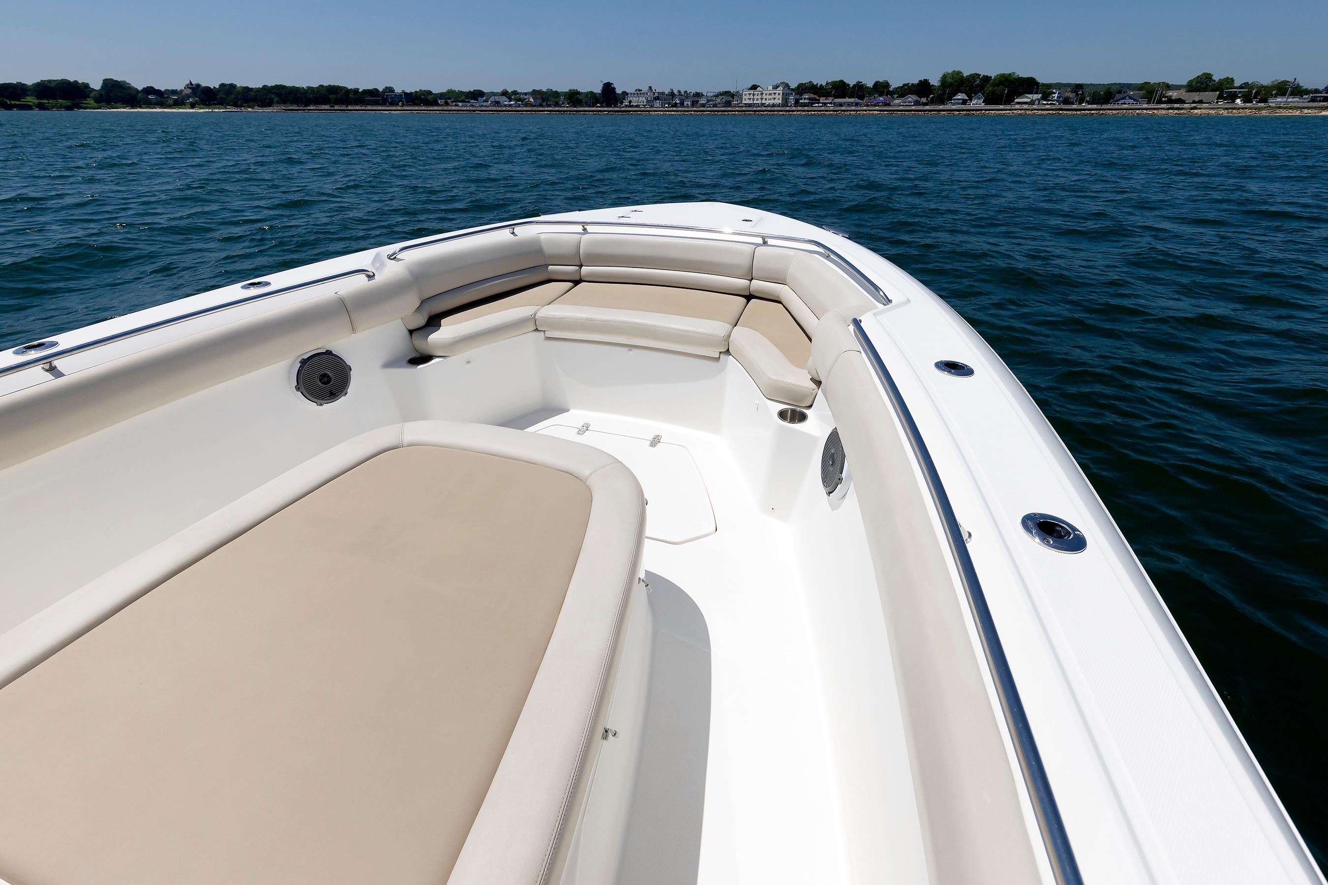 2016 Boston Whaler 330 Outrage boat interior with cushioned seating on calm water.