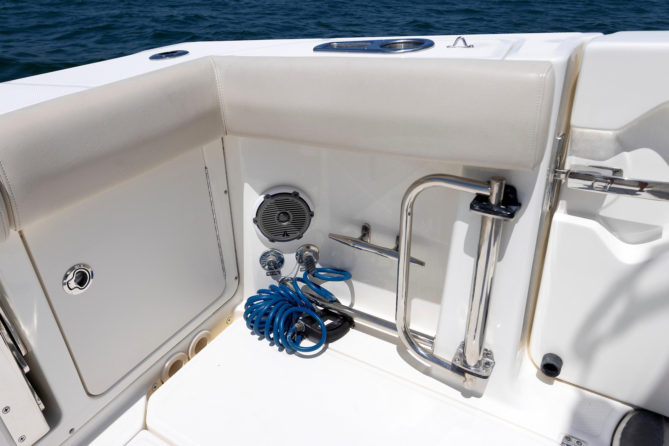 Boston Whaler 330 Outrage 2016 boat interior with coiled hose and speaker.