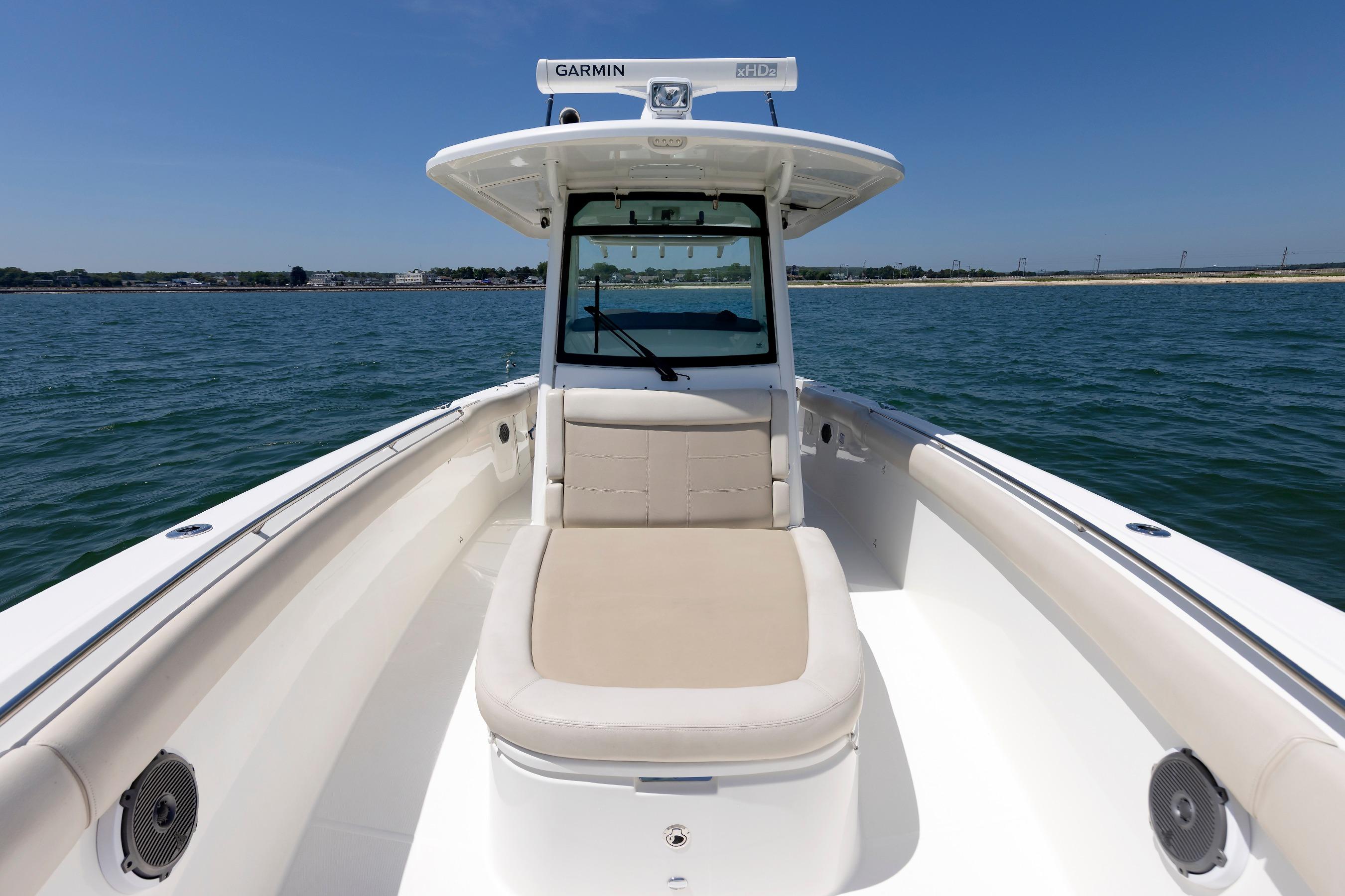 2016 Boston Whaler 330 Outrage boat on water, featuring spacious seating and Garmin equipment.