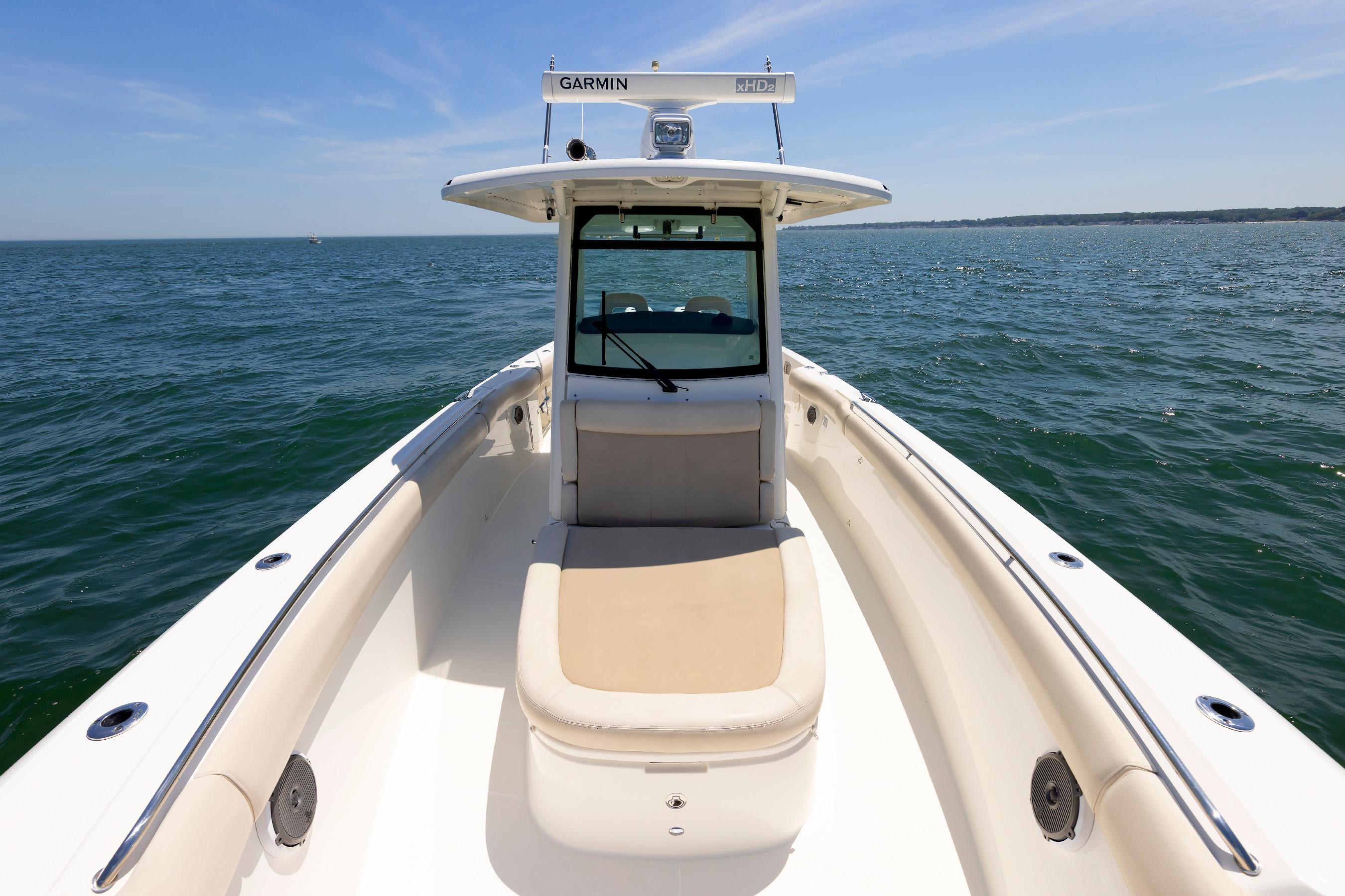 Boston Whaler 330 Outrage 2016 boat on open water, featuring spacious deck and clear skies.