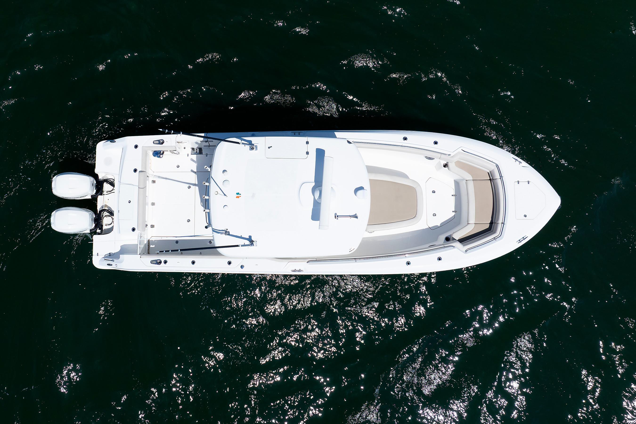 Aerial view of 2016 Boston Whaler 330 Outrage boat on dark water.