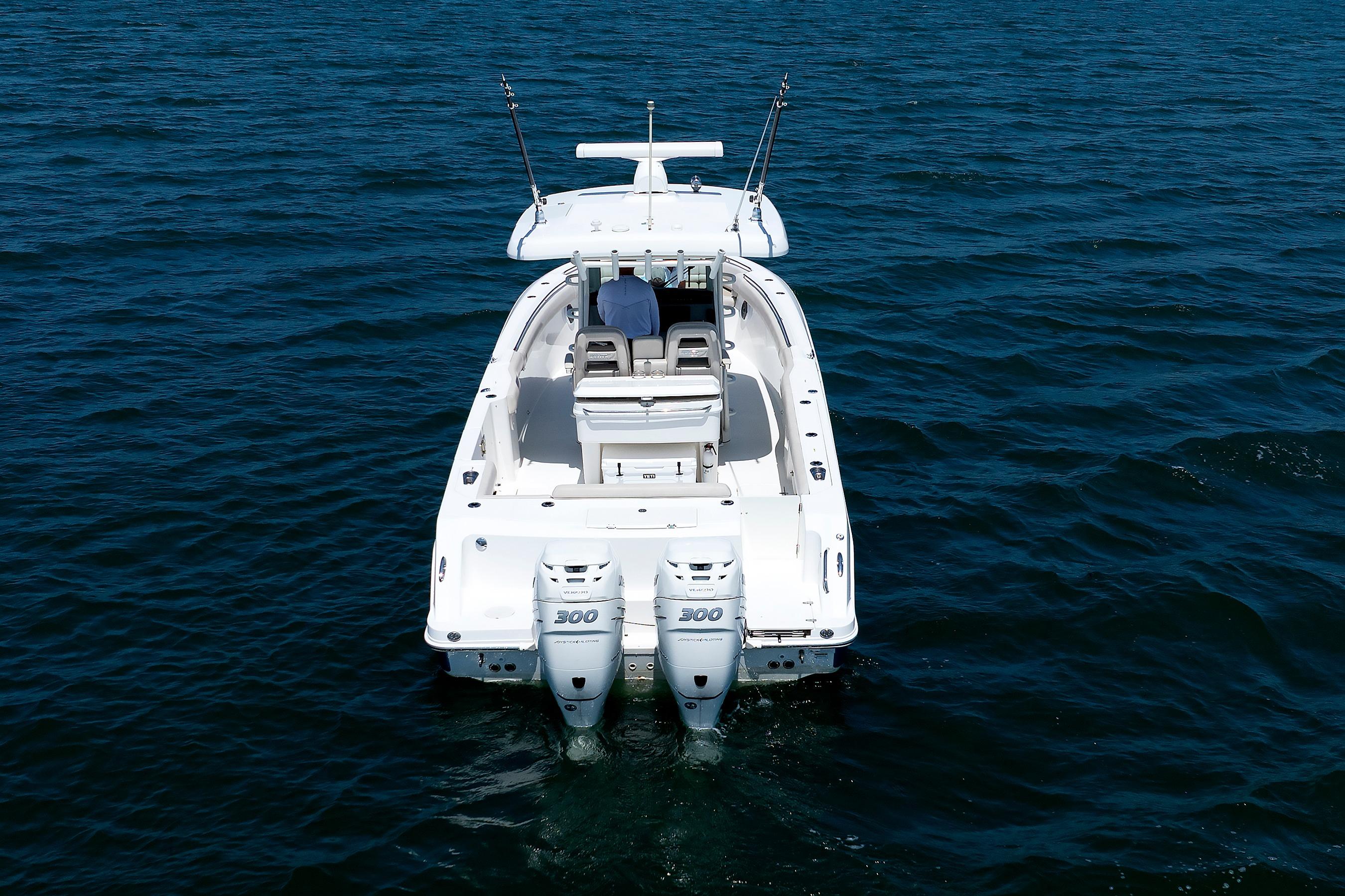 2016 Boston Whaler 330 Outrage boat on open water, rear view.