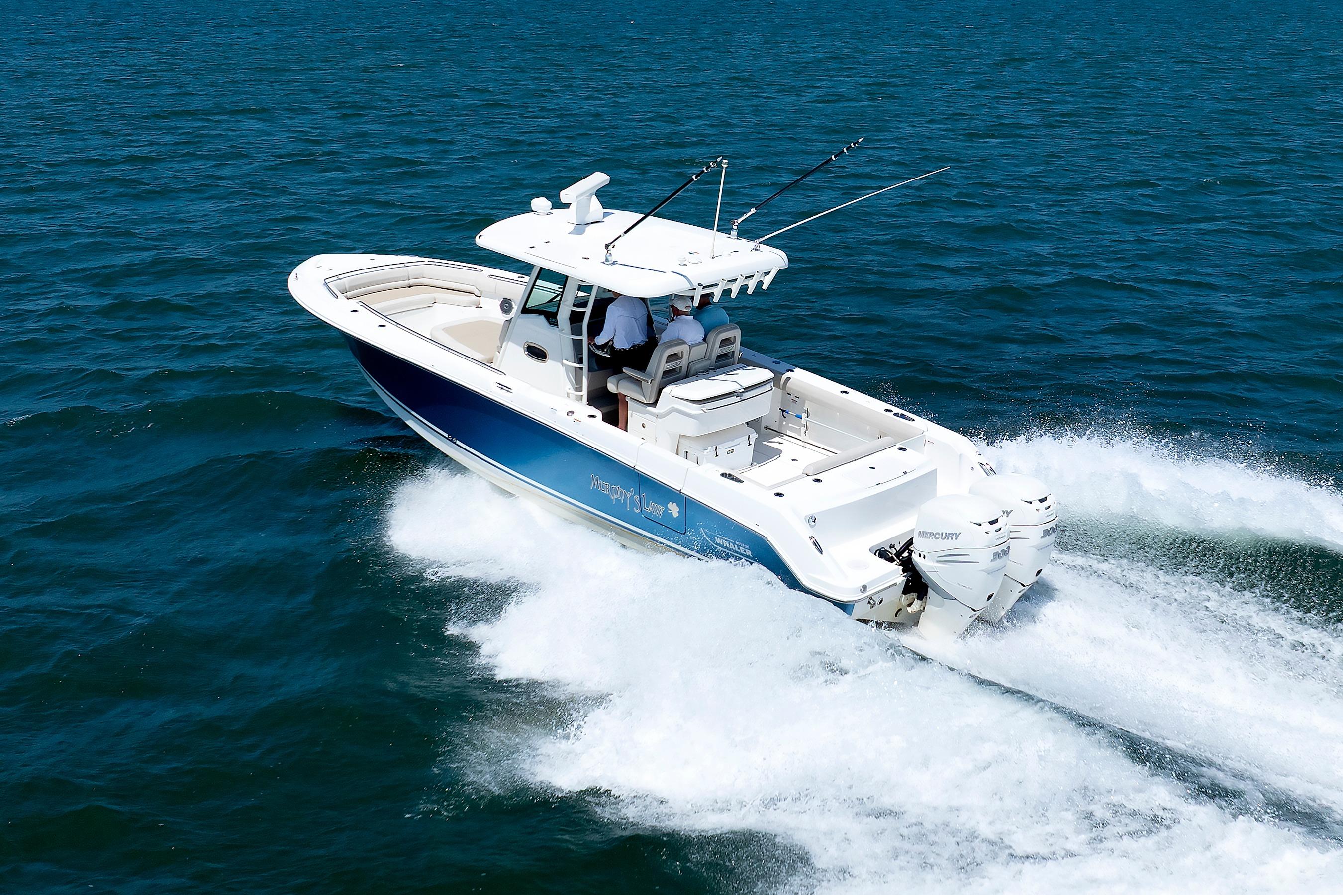 2016 Boston Whaler 330 Outrage cruising on open water, showcasing sleek design and powerful engines.
