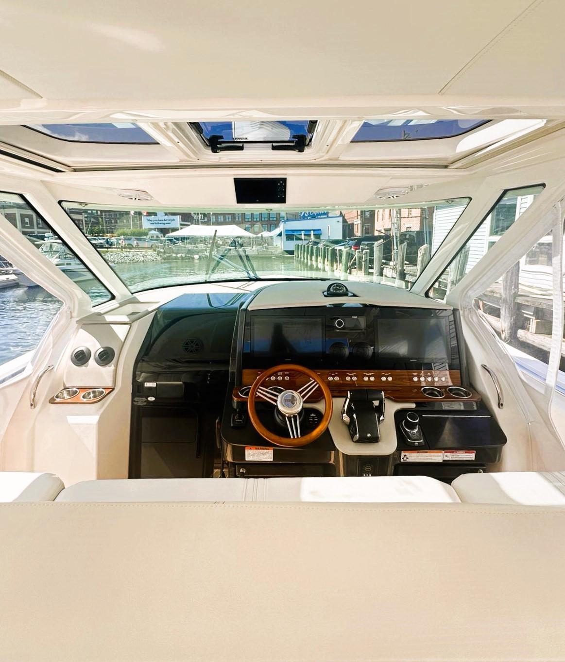 2024 Tiara Yachts 43 LS helm with modern controls and panoramic view.