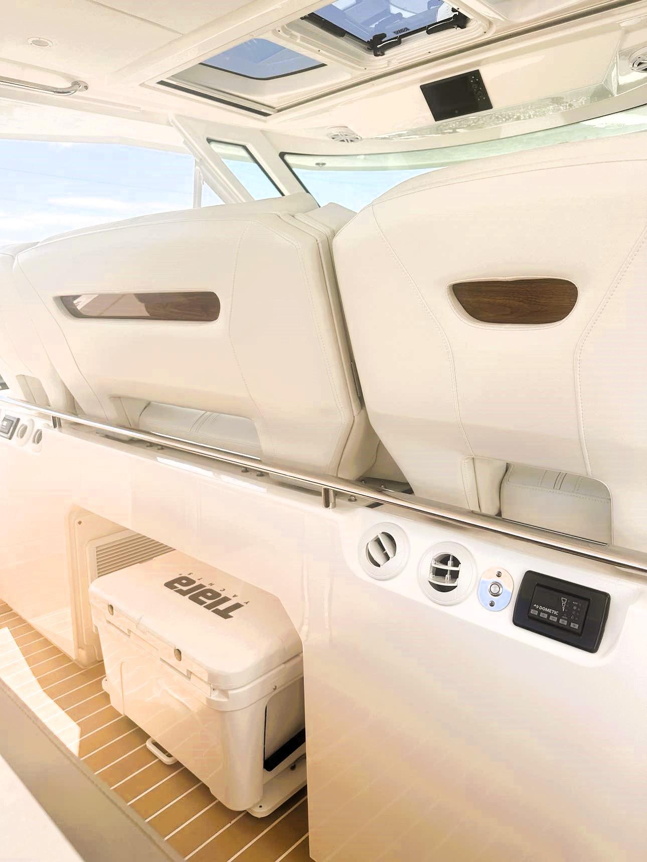 2024 Tiara Yachts 43 LS interior with white seating and modern controls.