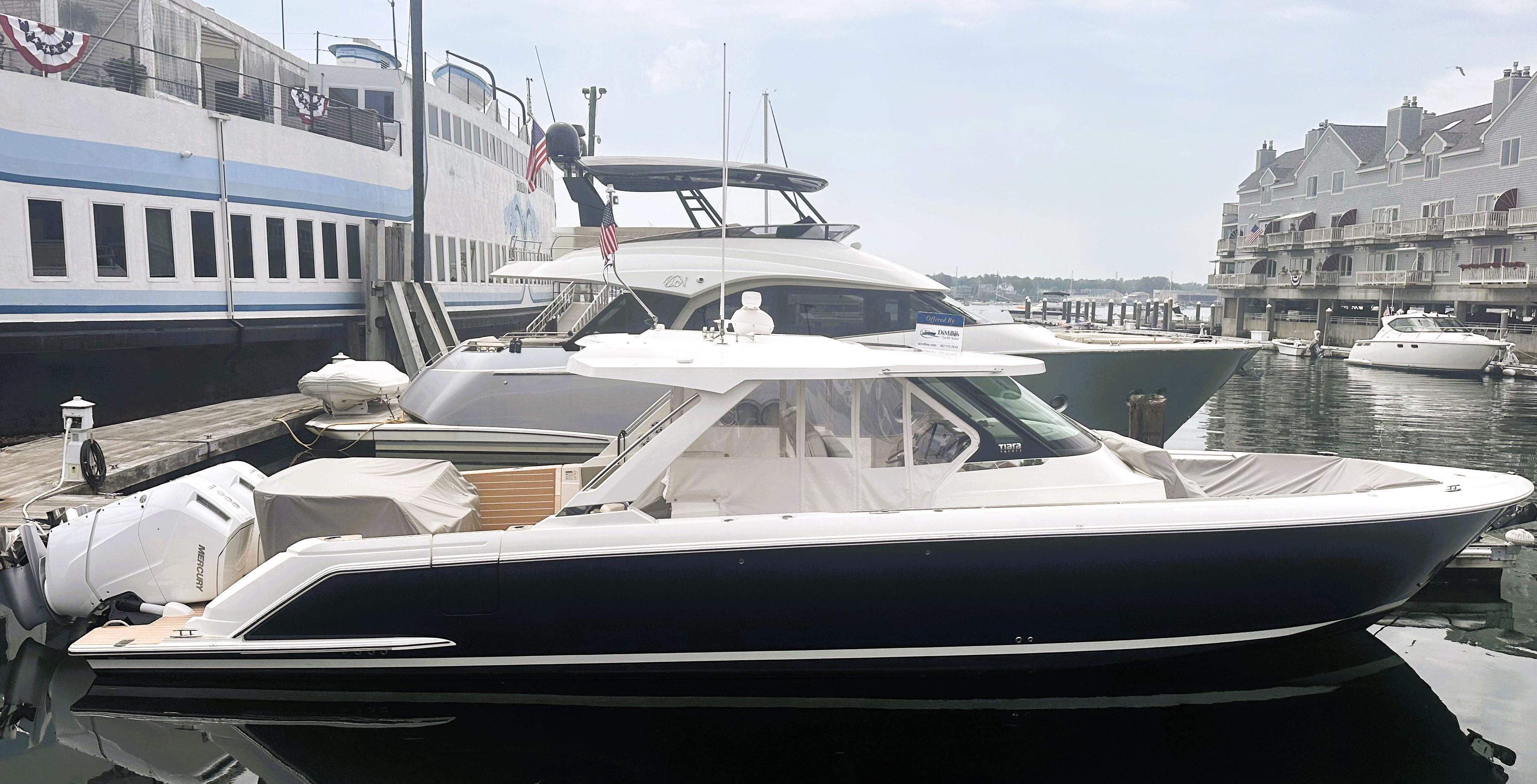 2024 Tiara Yachts 43 LS docked at marina, showcasing sleek design and luxury features.