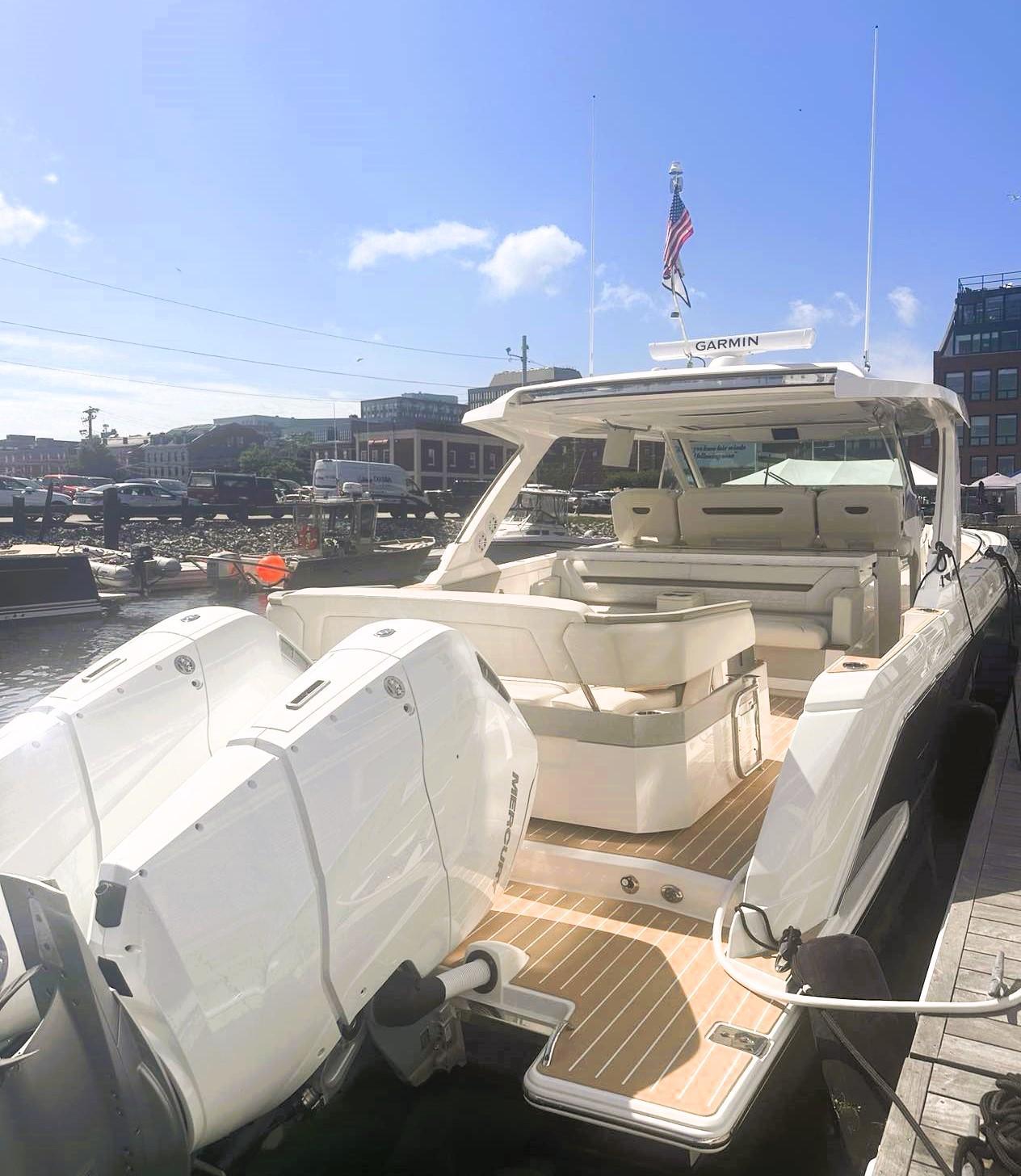 2024 Tiara Yachts 43 LS luxury boat docked, featuring spacious seating and powerful engines.