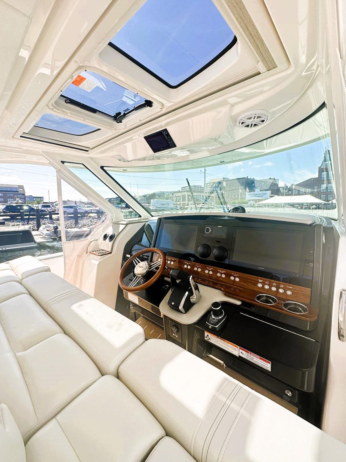 2024 Tiara Yachts 43 LS interior with luxurious seating and modern dashboard controls.