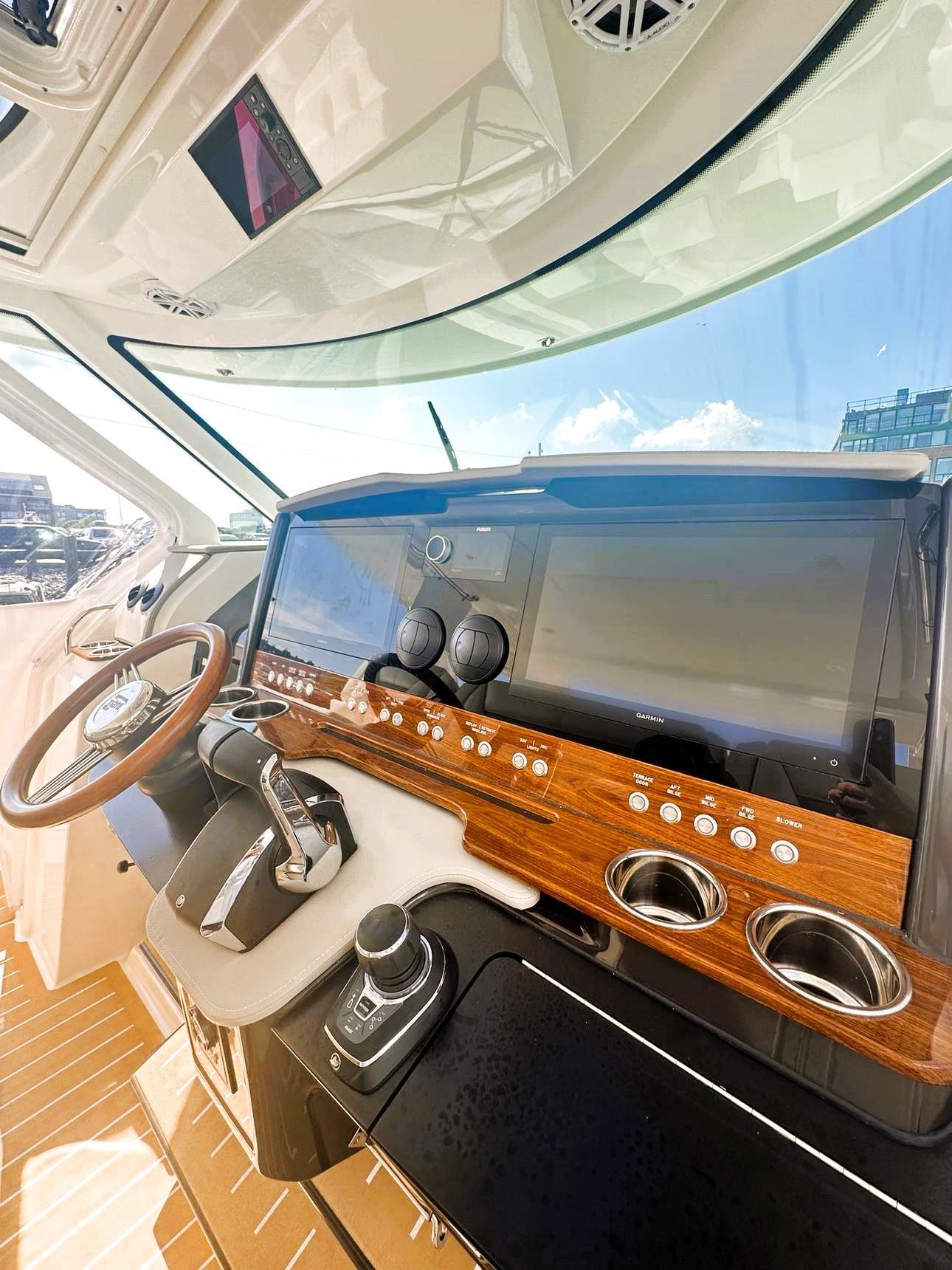 2024 Tiara Yachts 43 LS helm with modern controls and wood accents.