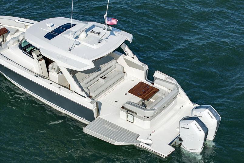 2024 Tiara Yachts 43 LS luxury boat on water, featuring spacious deck and twin Mercury engines.