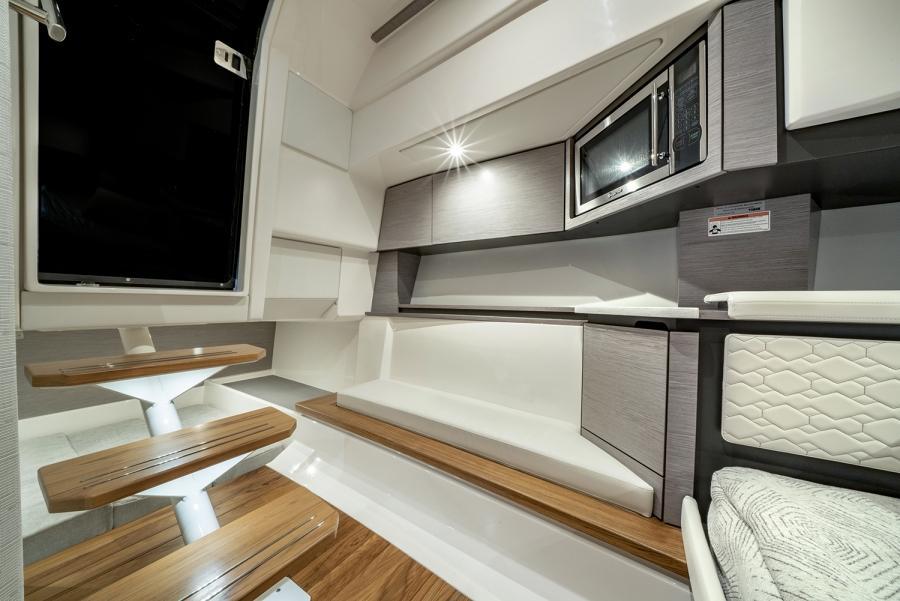 2024 Tiara Yachts 43 LS interior with modern seating and wooden steps.