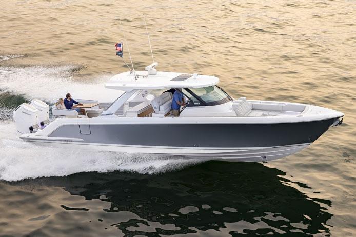 2024 Tiara Yachts 43 LS cruising on open water at sunset.