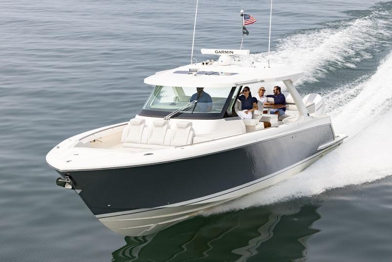 2024 Tiara Yachts 43 LS cruising on open water with passengers onboard.