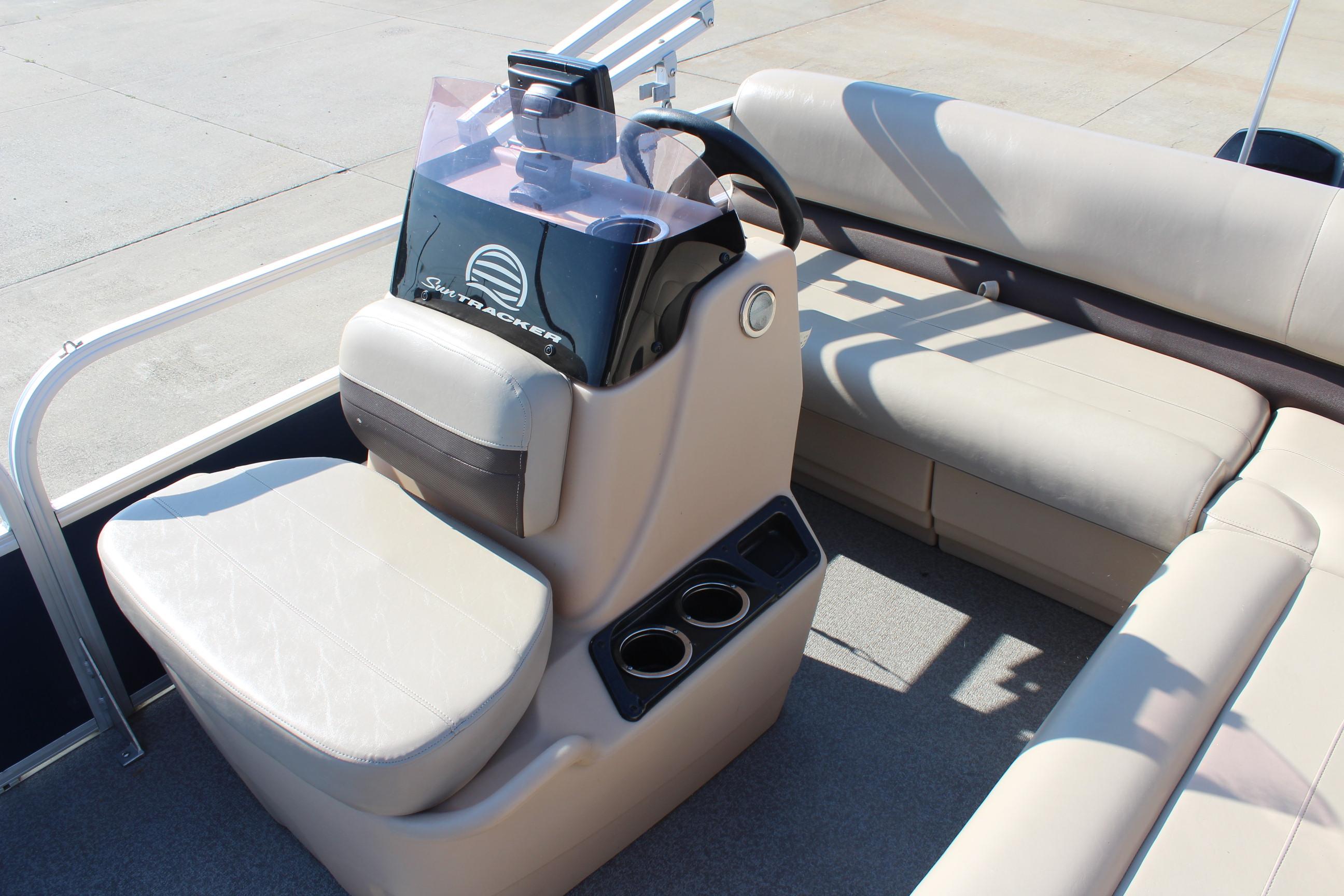 2019 Sun Tracker Bass Buggy 16 XL Select boat interior with beige seating and steering console.