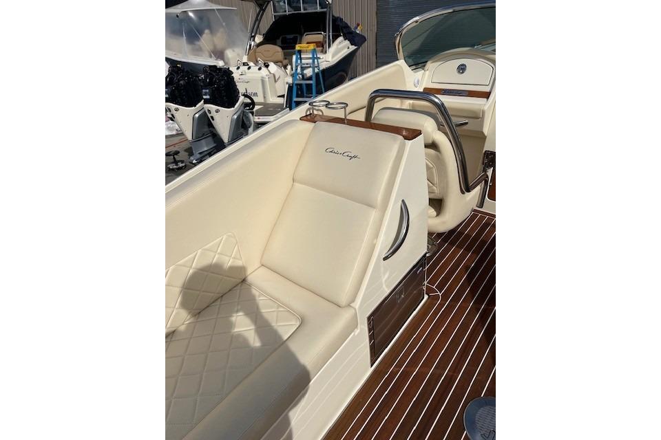 2017 Chris-Craft Corsair 32 boat interior with cream leather seating and wood accents.