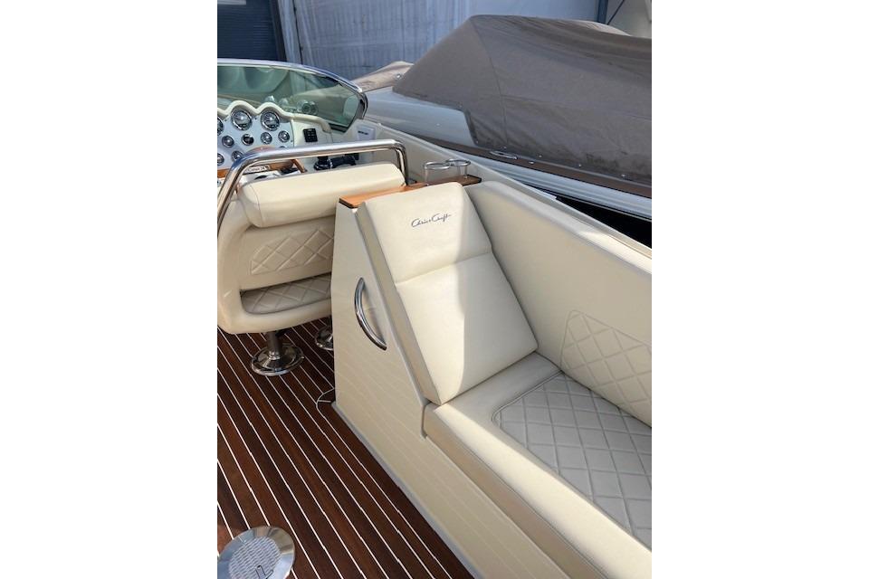 Luxurious interior of 2017 Chris-Craft Corsair 32 with elegant cream seating and polished dashboard.