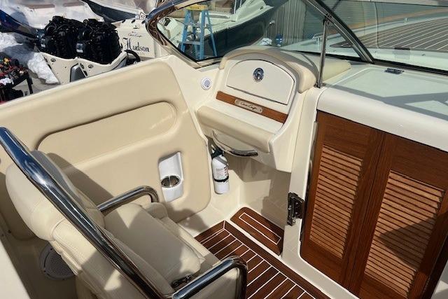 2017 Chris-Craft Corsair 32 interior with beige seating and wooden accents.