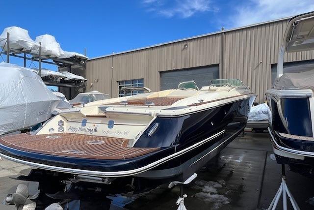 2017 Chris-Craft Corsair 32 boat in storage, Southampton, NY, with blue hull and wooden deck.