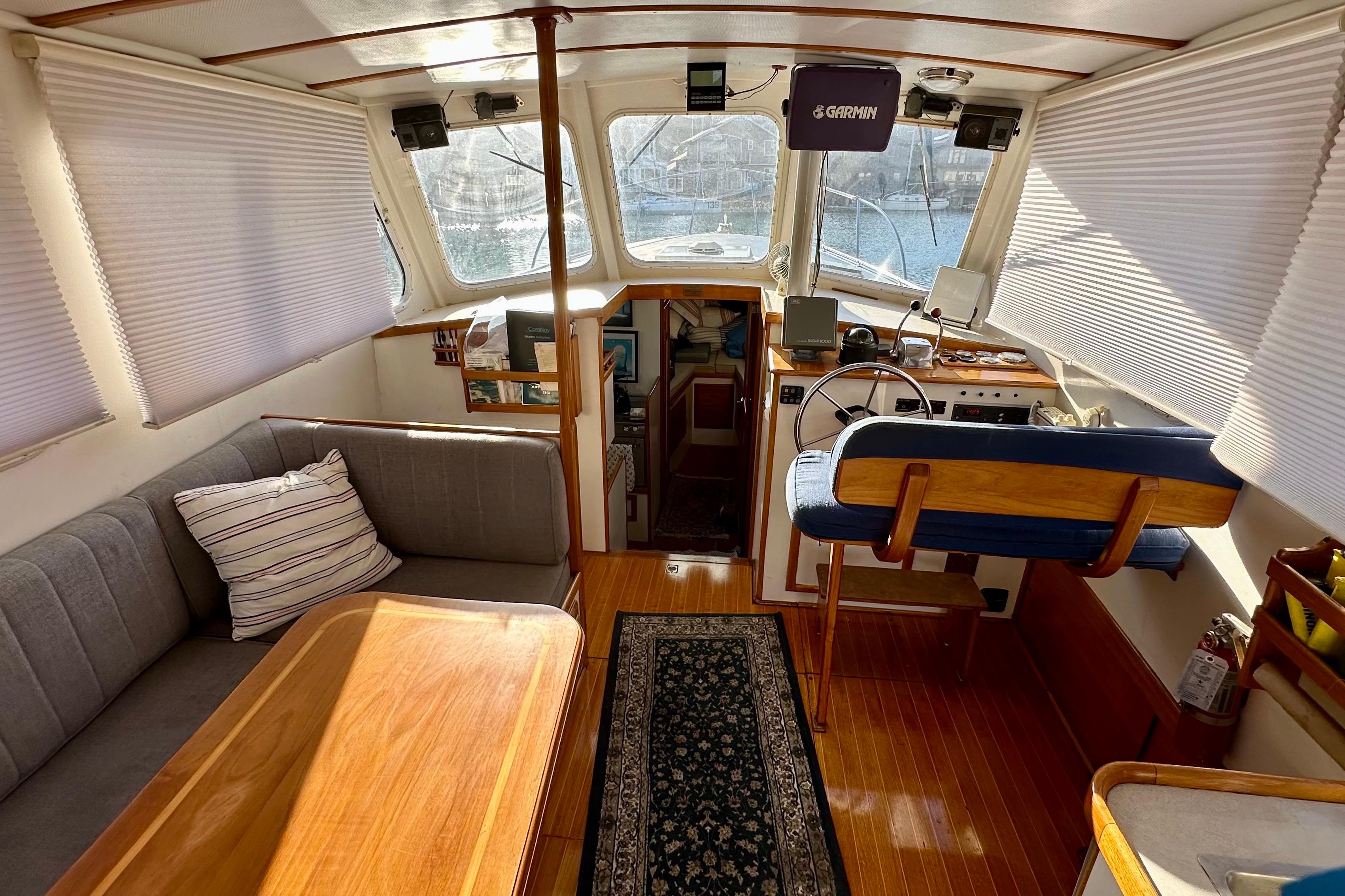1982 Jarvis Newman Flybridge Cruiser interior with helm, seating, and wooden accents.