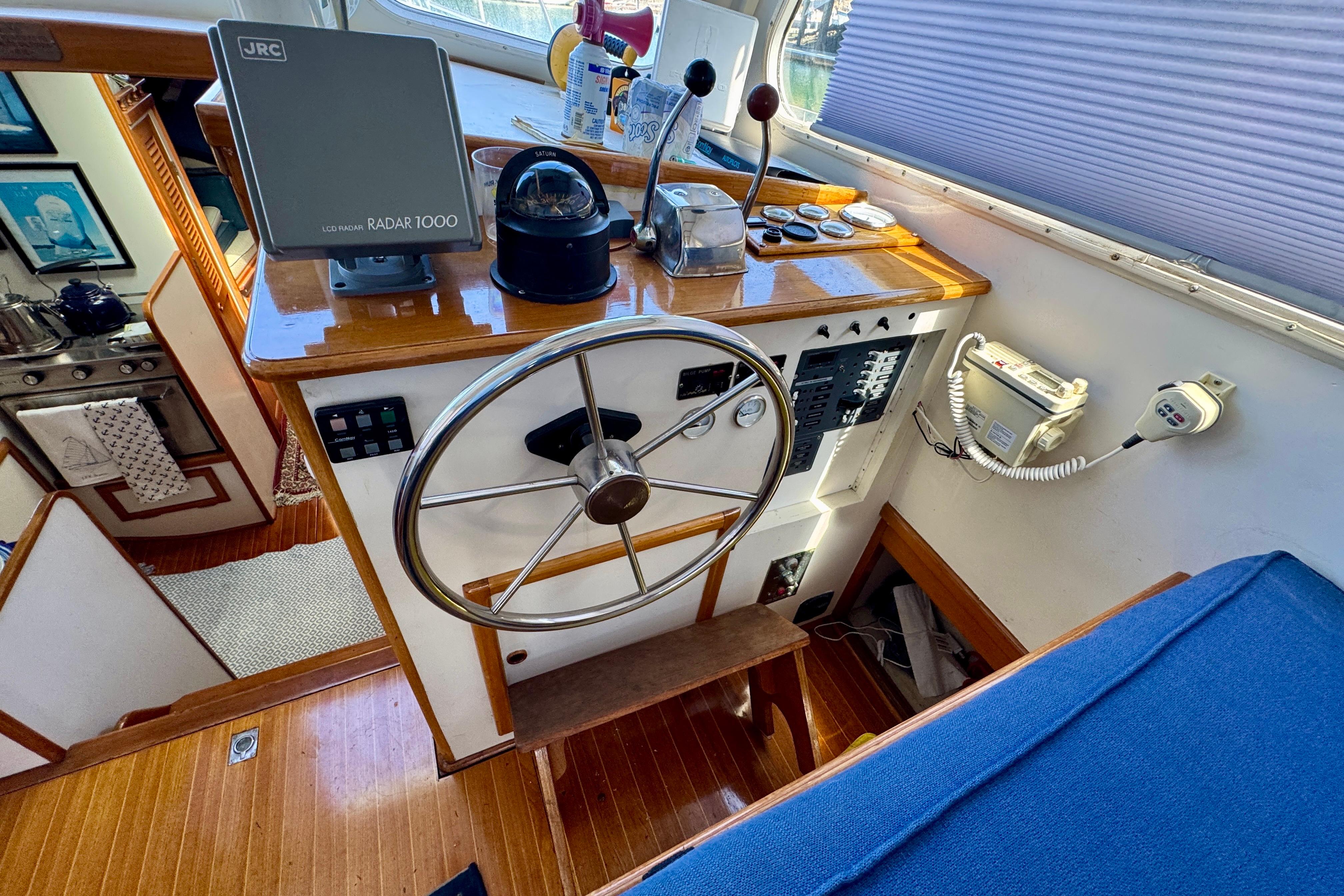 1982 Jarvis Newman Flybridge Cruiser helm with steering wheel and navigation equipment.