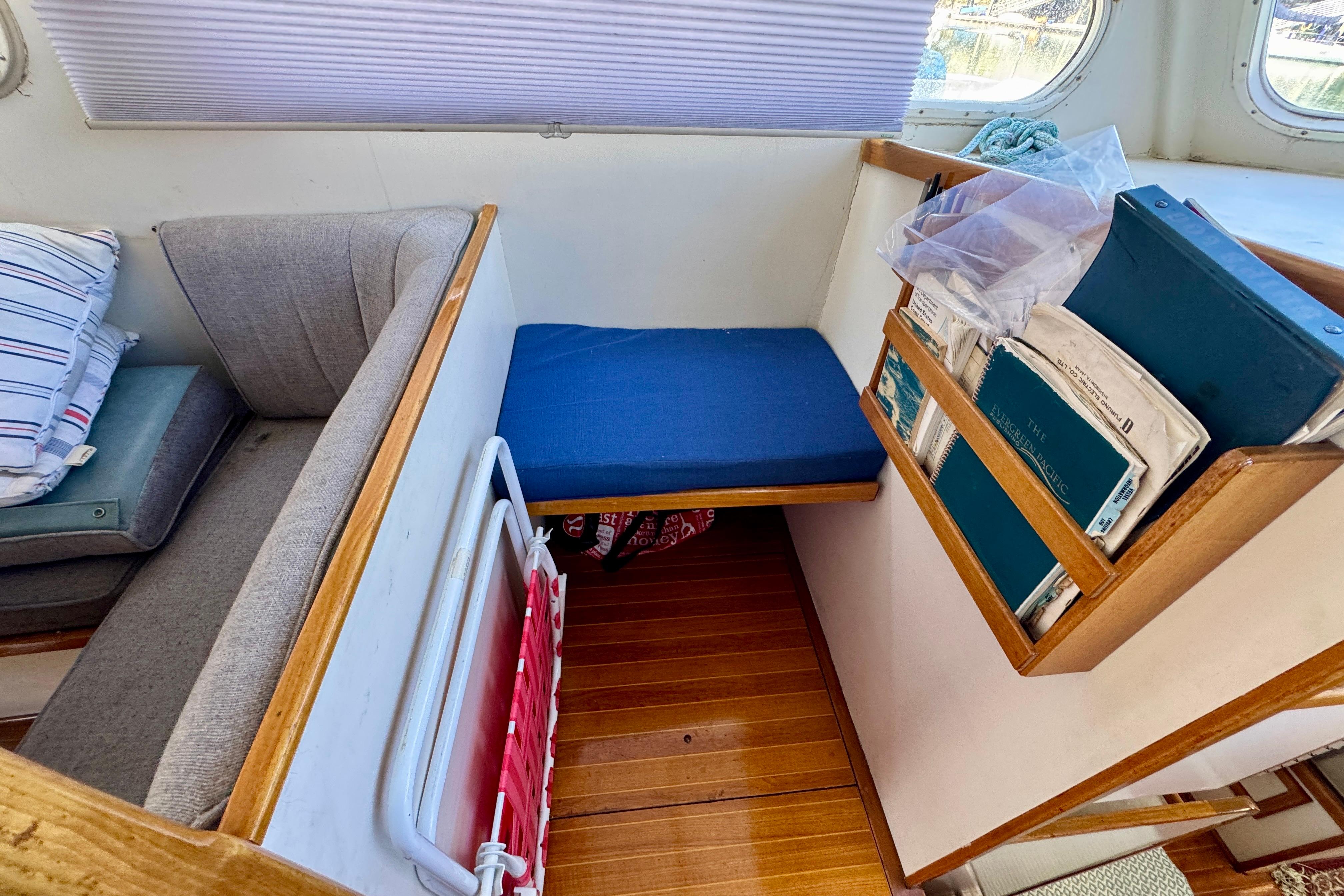 1982 Jarvis Newman Flybridge Cruiser interior with seating, cushions, and storage shelves.
