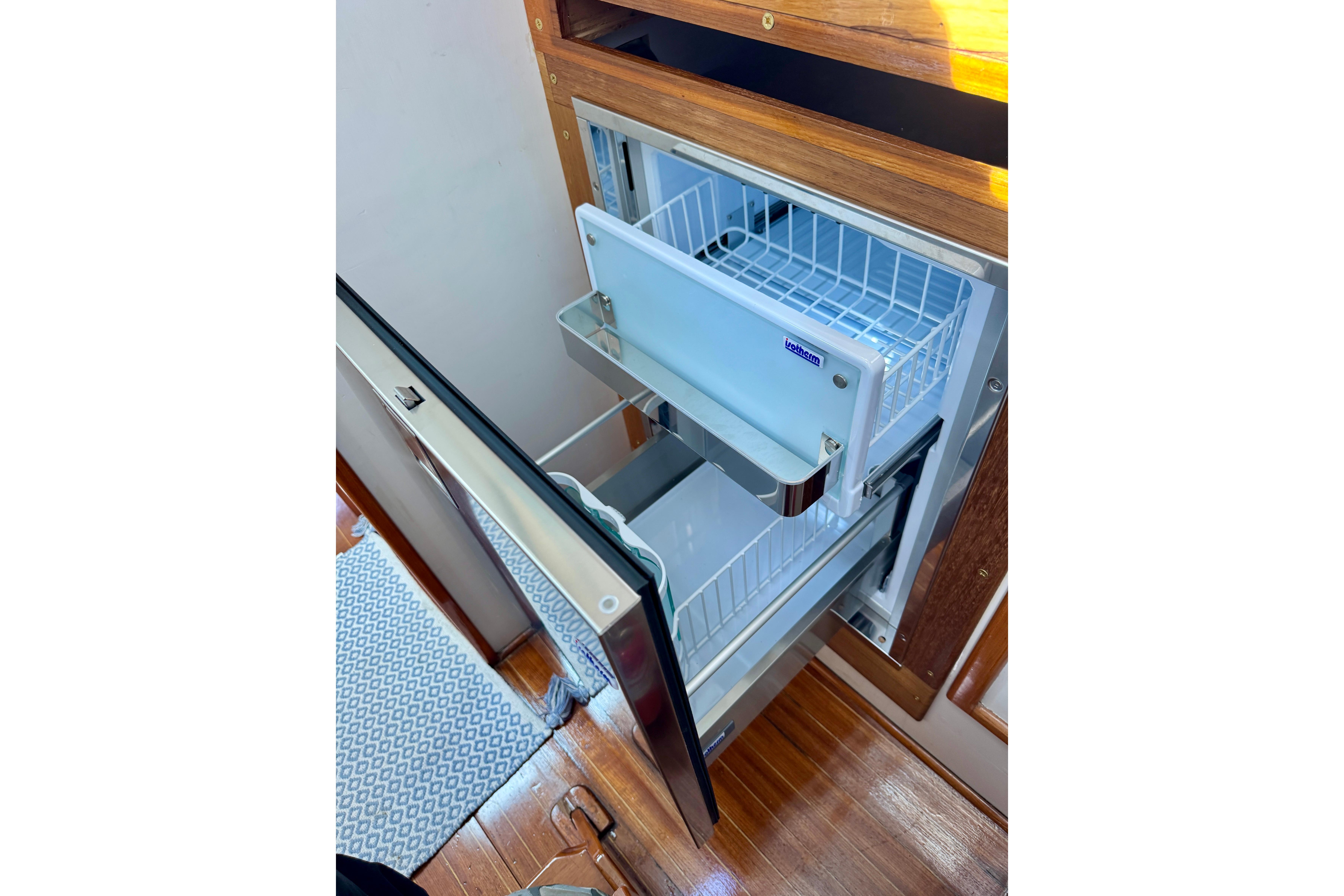 1982 Jarvis Newman Flybridge Cruiser with open refrigerator drawer, showcasing interior storage.