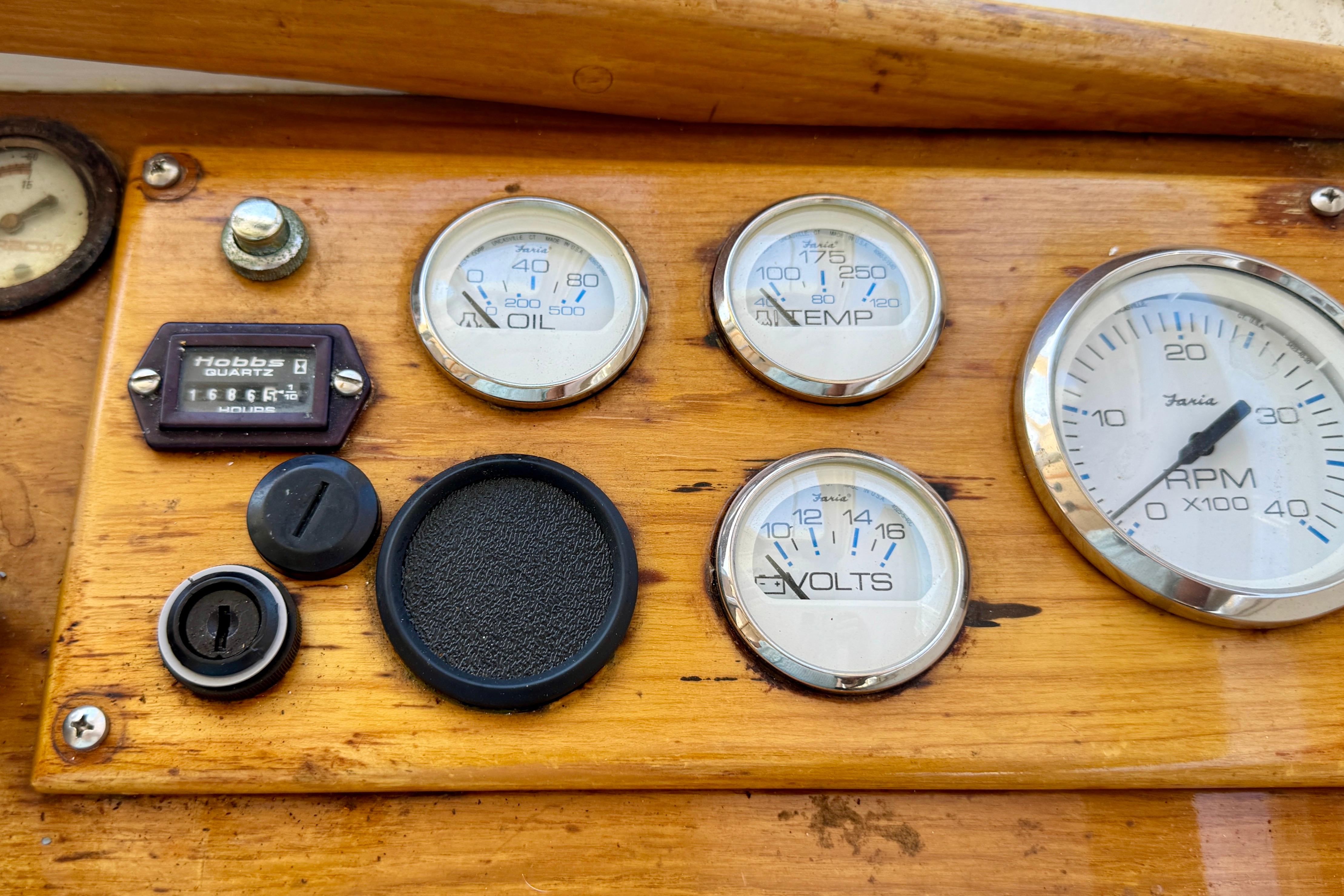 1982 Jarvis Newman Flybridge Cruiser dashboard with gauges and controls on wooden panel.