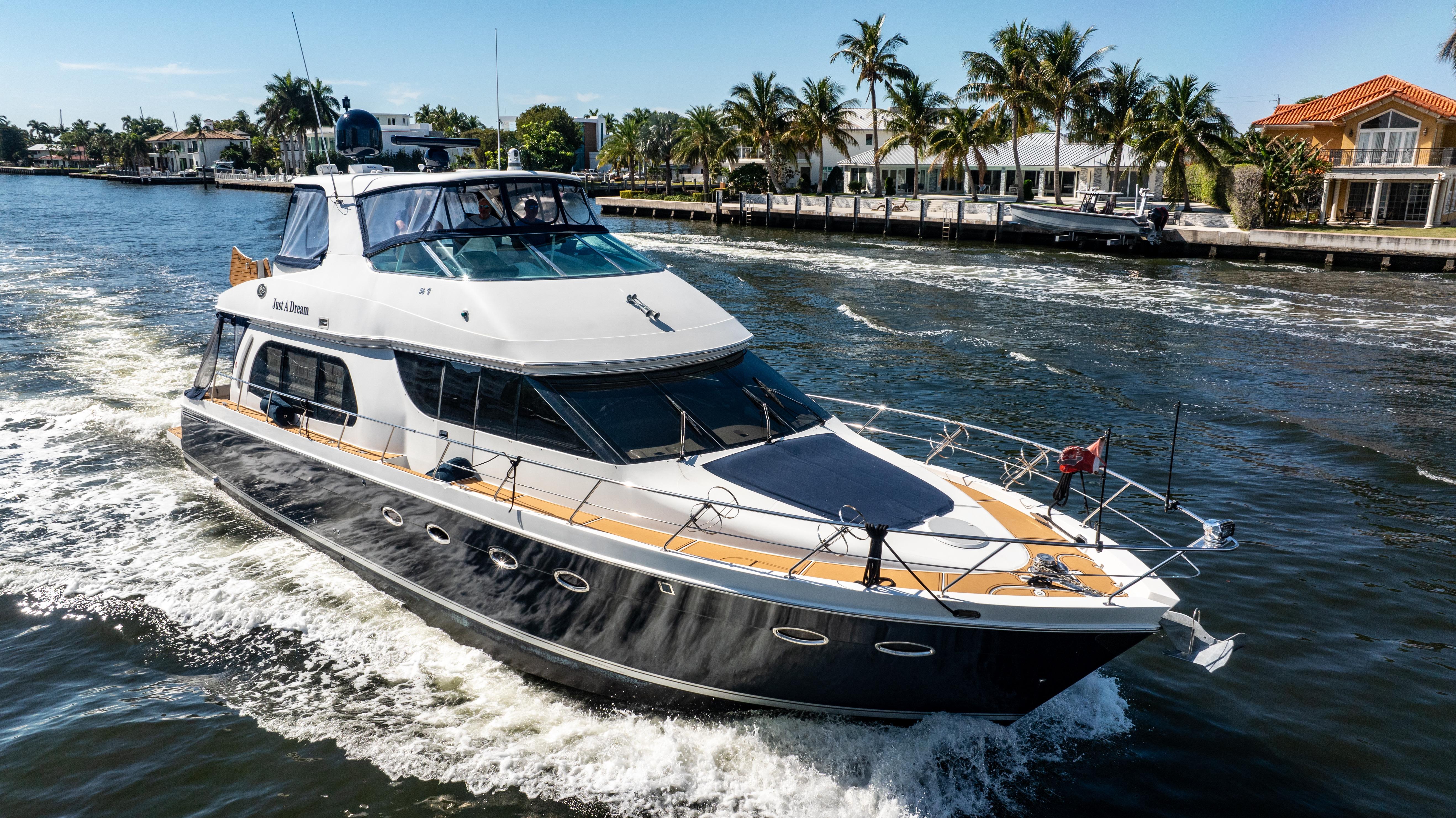 Carver-56 Voyager 2005-Just A Dream FL-US-2005 Carver 56 Voyager yacht cruising on a sunny day with palm trees in the background.-9669425