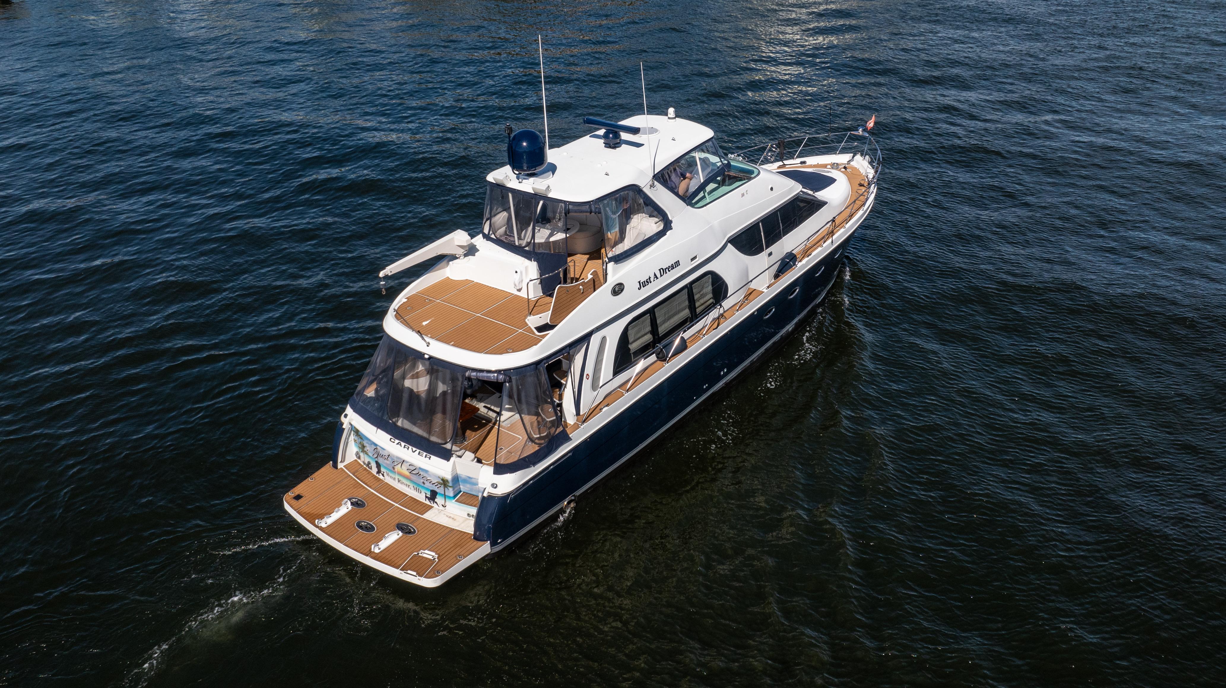 Carver-56 Voyager 2005-Just A Dream FL-US-2005 Carver 56 Voyager yacht cruising on open water, aerial view.-9669425 | Thumbnail
