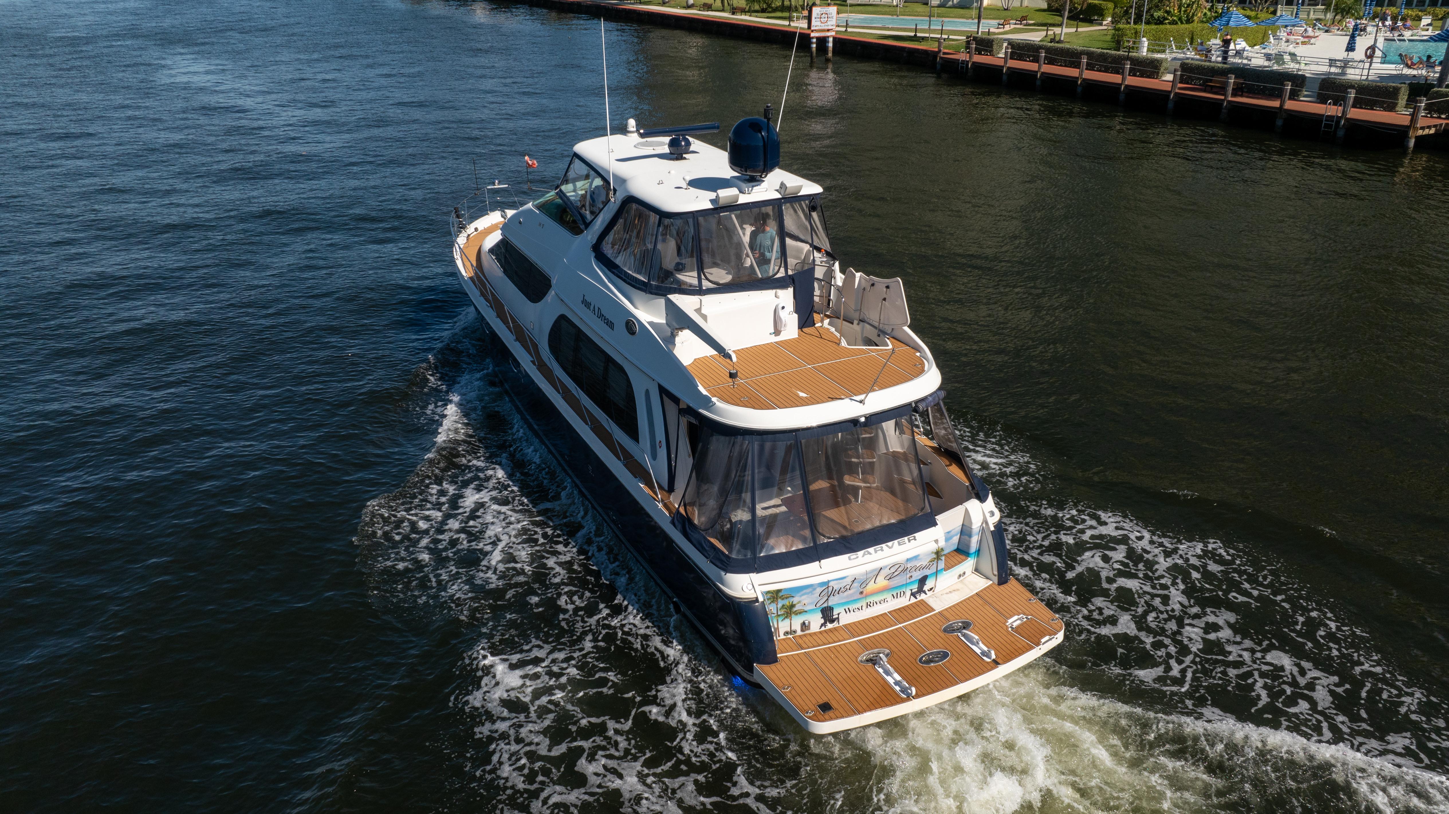 Carver-56 Voyager 2005-Just A Dream FL-US-2005 Carver 56 Voyager yacht cruising on a river, aerial view.-9669425 | Thumbnail