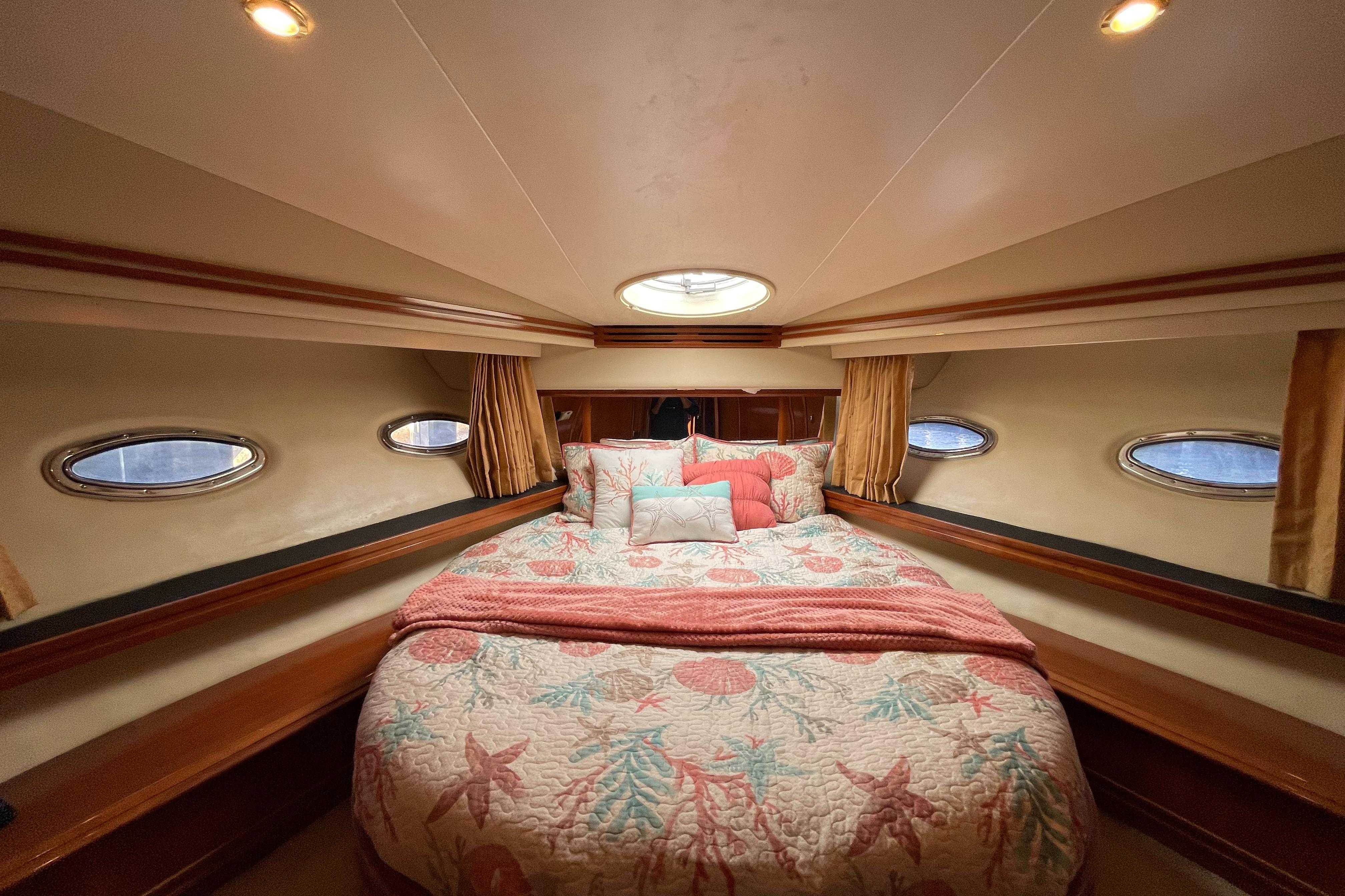 Carver-56 Voyager 2005-Just A Dream FL-US-Luxurious bedroom interior of 2005 Carver 56 Voyager yacht with elegant bedding and porthole windows.-9669425 | Thumbnail