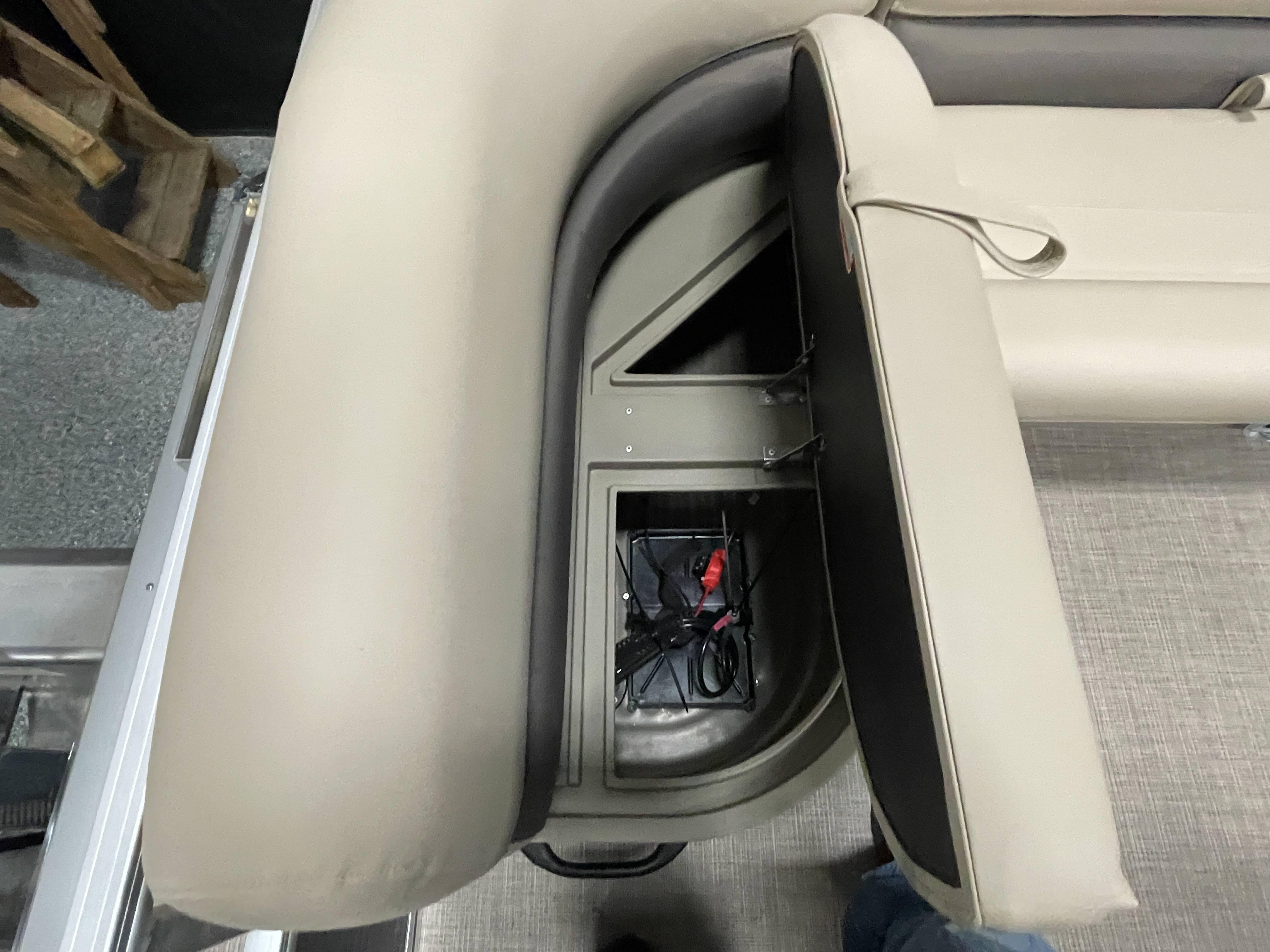 2025 Sun Tracker Bass Buggy 16 XL Select, open storage compartment with beige seating.