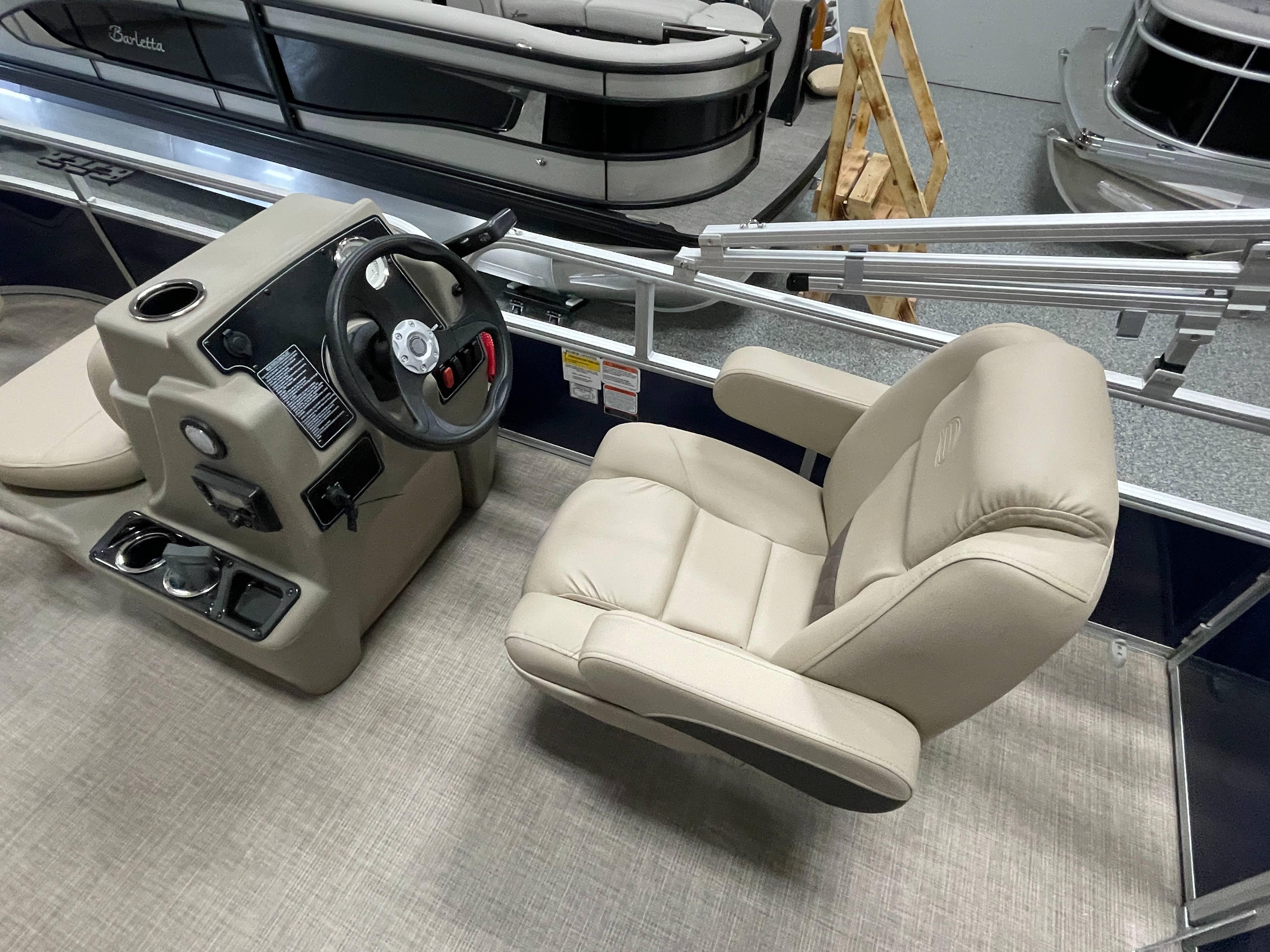 2025 Sun Tracker Bass Buggy 16 XL Select boat interior with steering console and captain's chair.