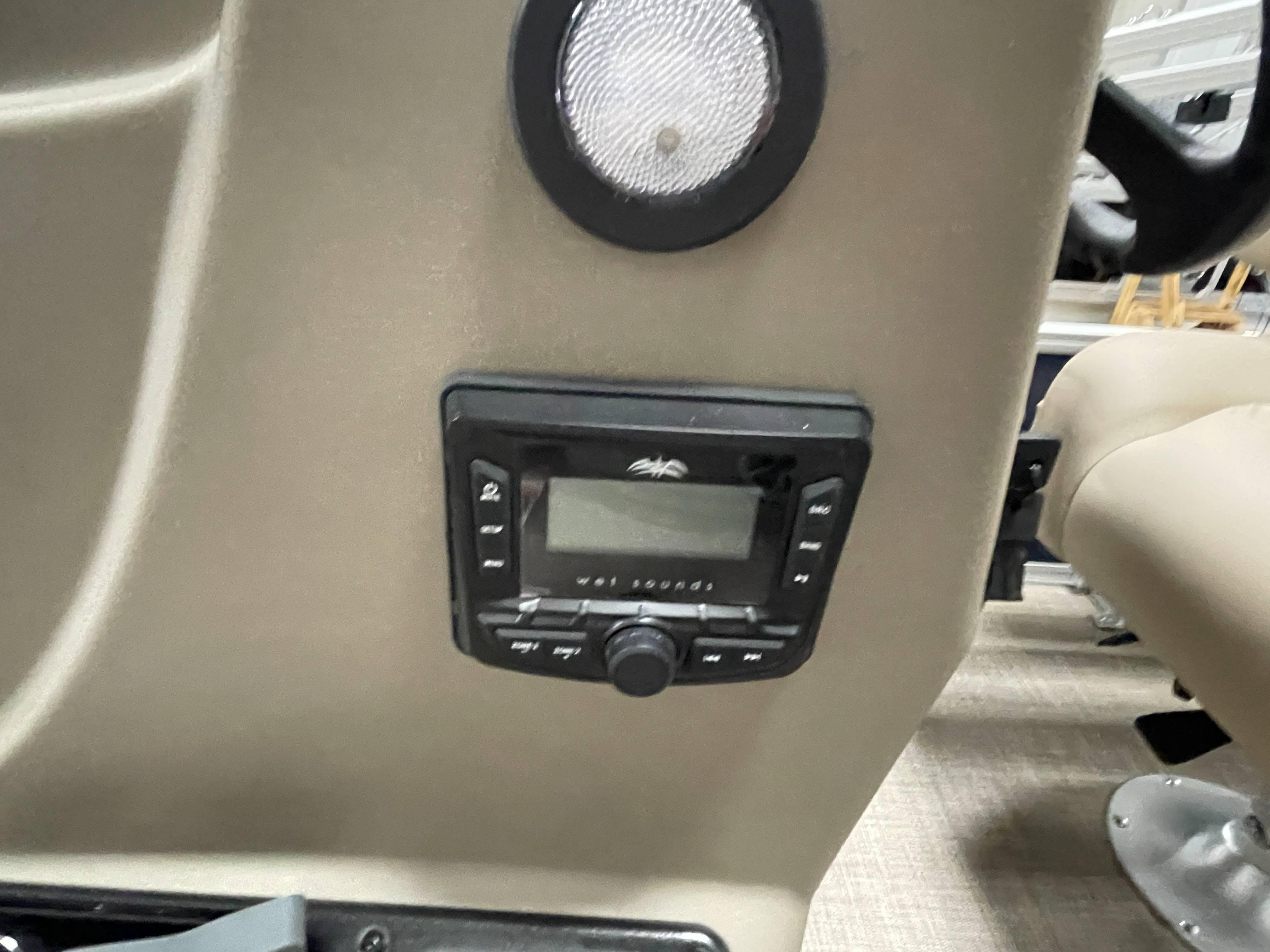 2025 Sun Tracker Bass Buggy 16 XL Select dashboard with audio controls and speaker.